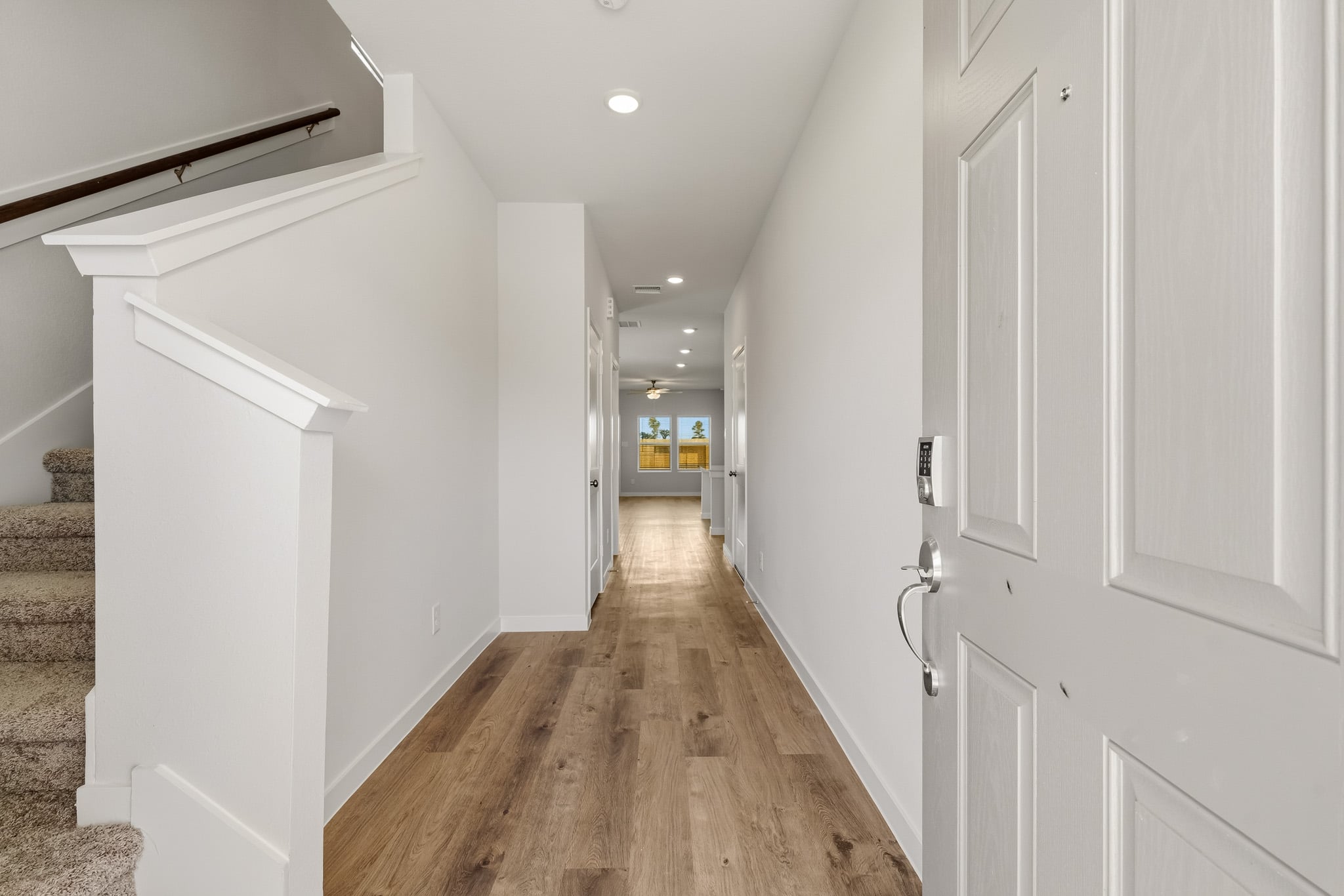 A hallway with white doors.