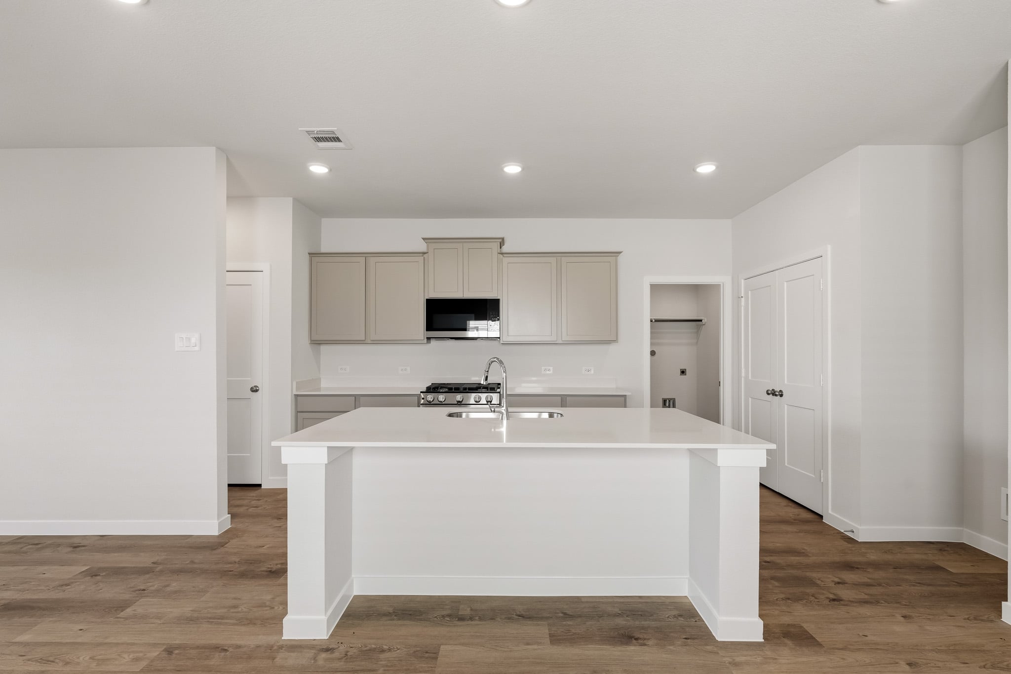 A white kitchen with white cabinets.