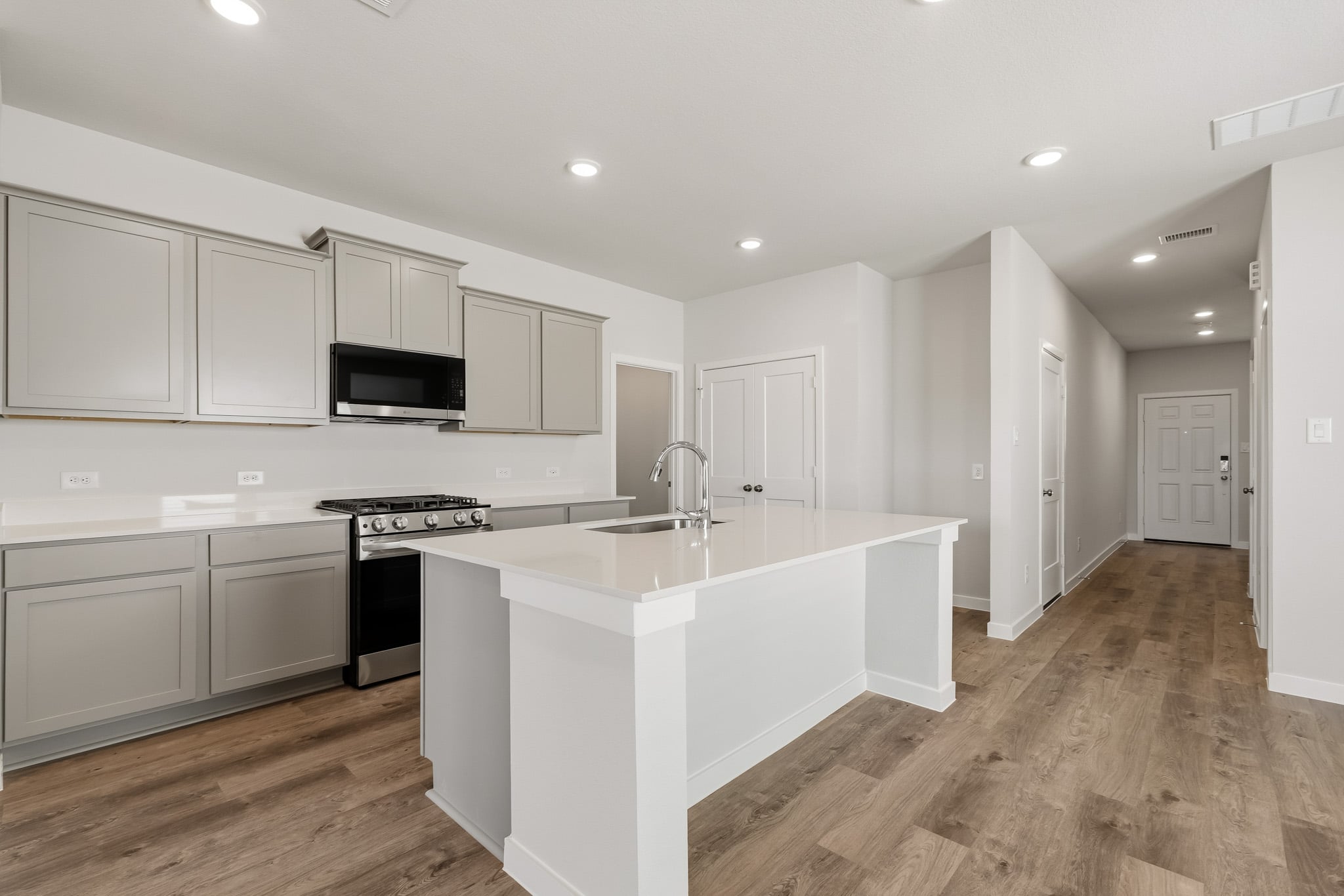 A kitchen with white cabinets.