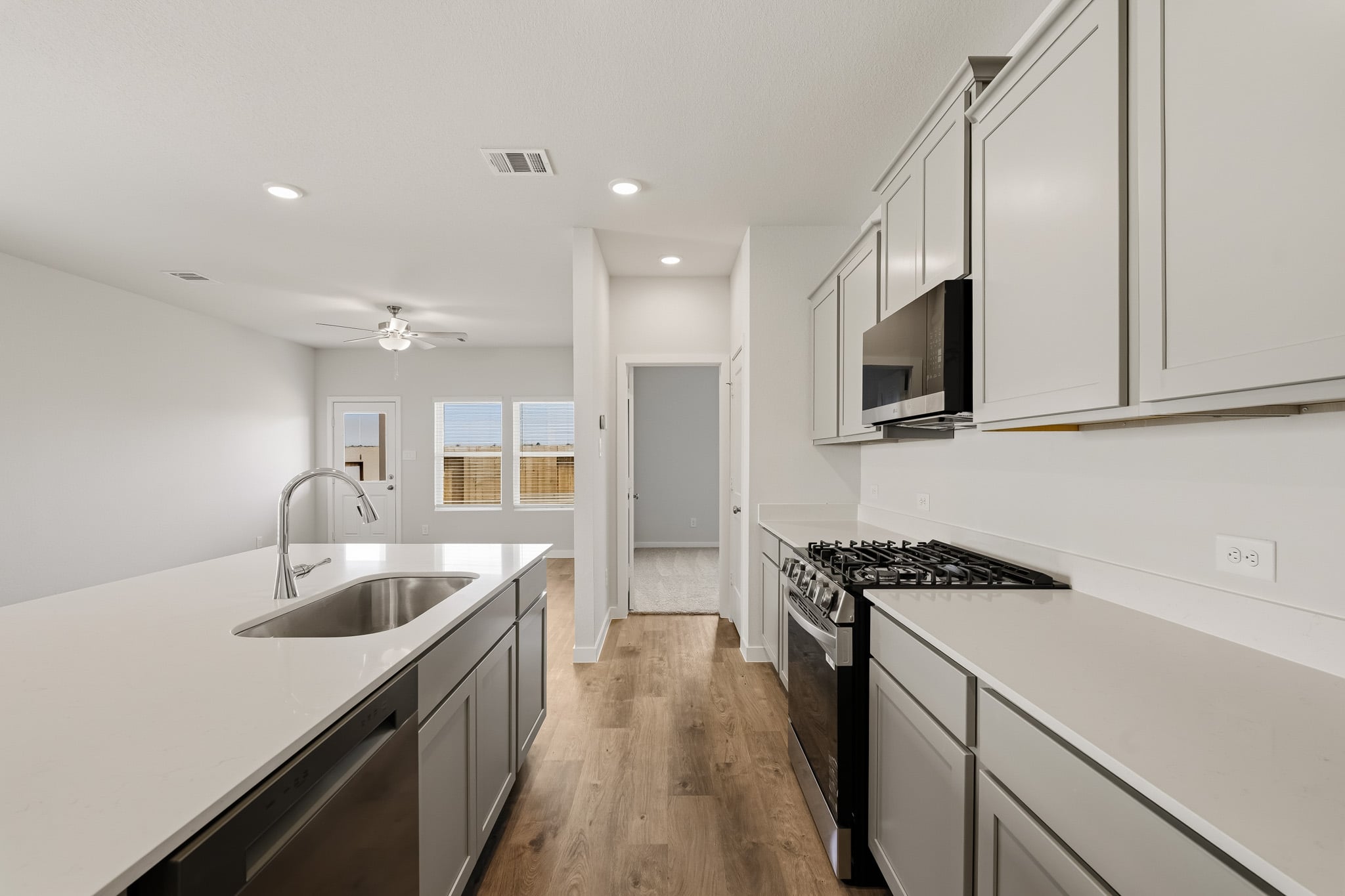 A kitchen with white cabinets.