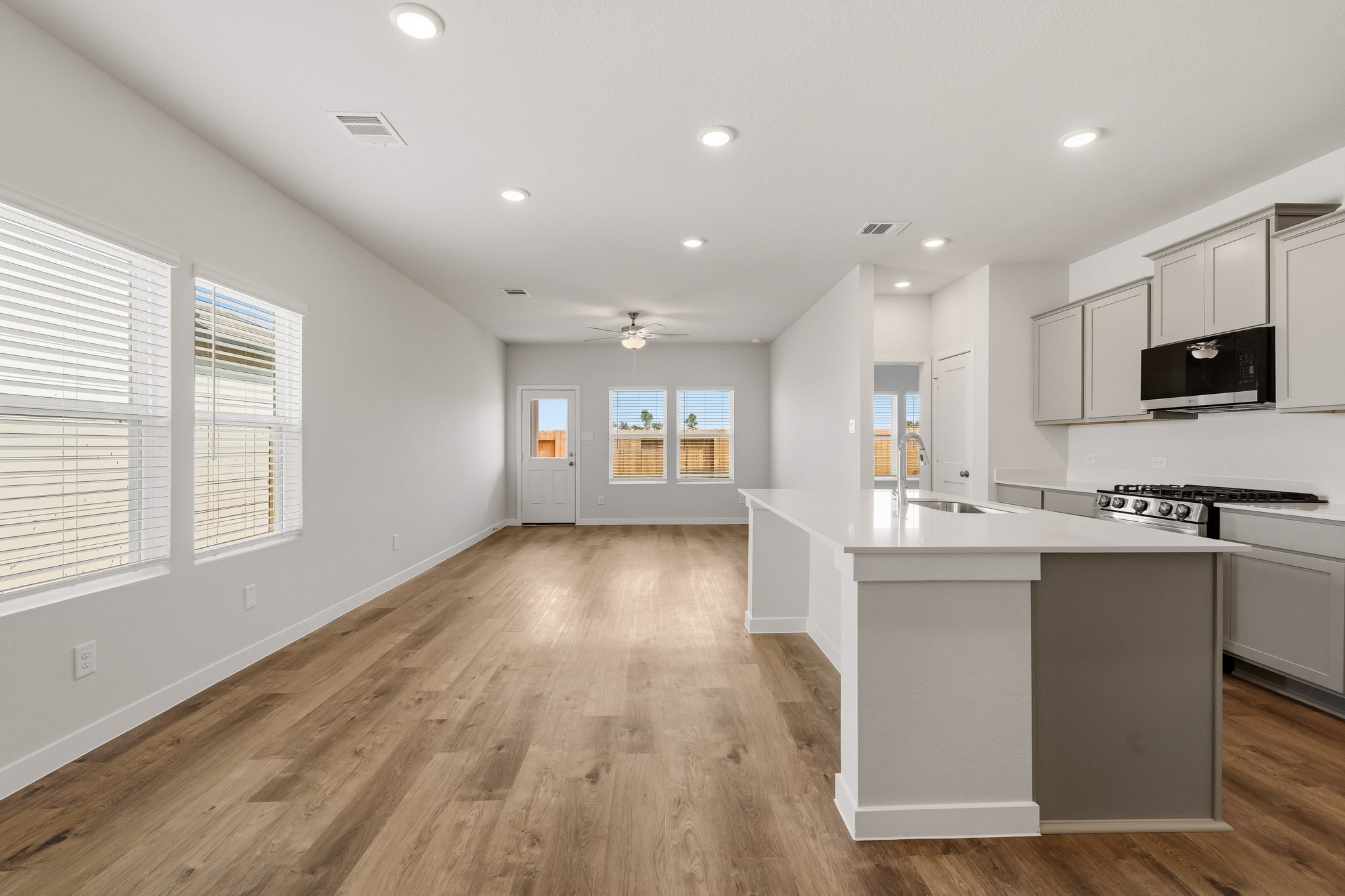 A kitchen with white cabinets.
