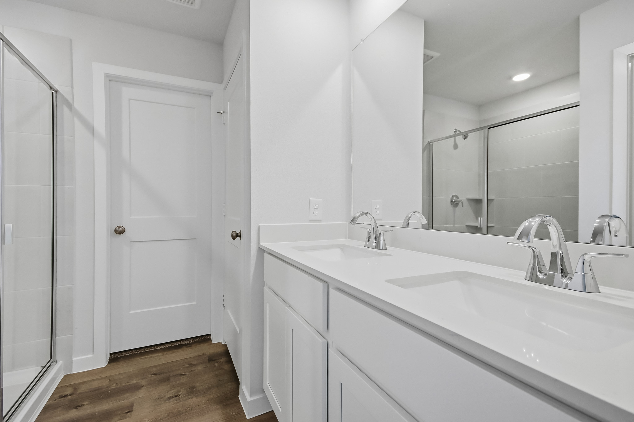 A bathroom with a large mirror.