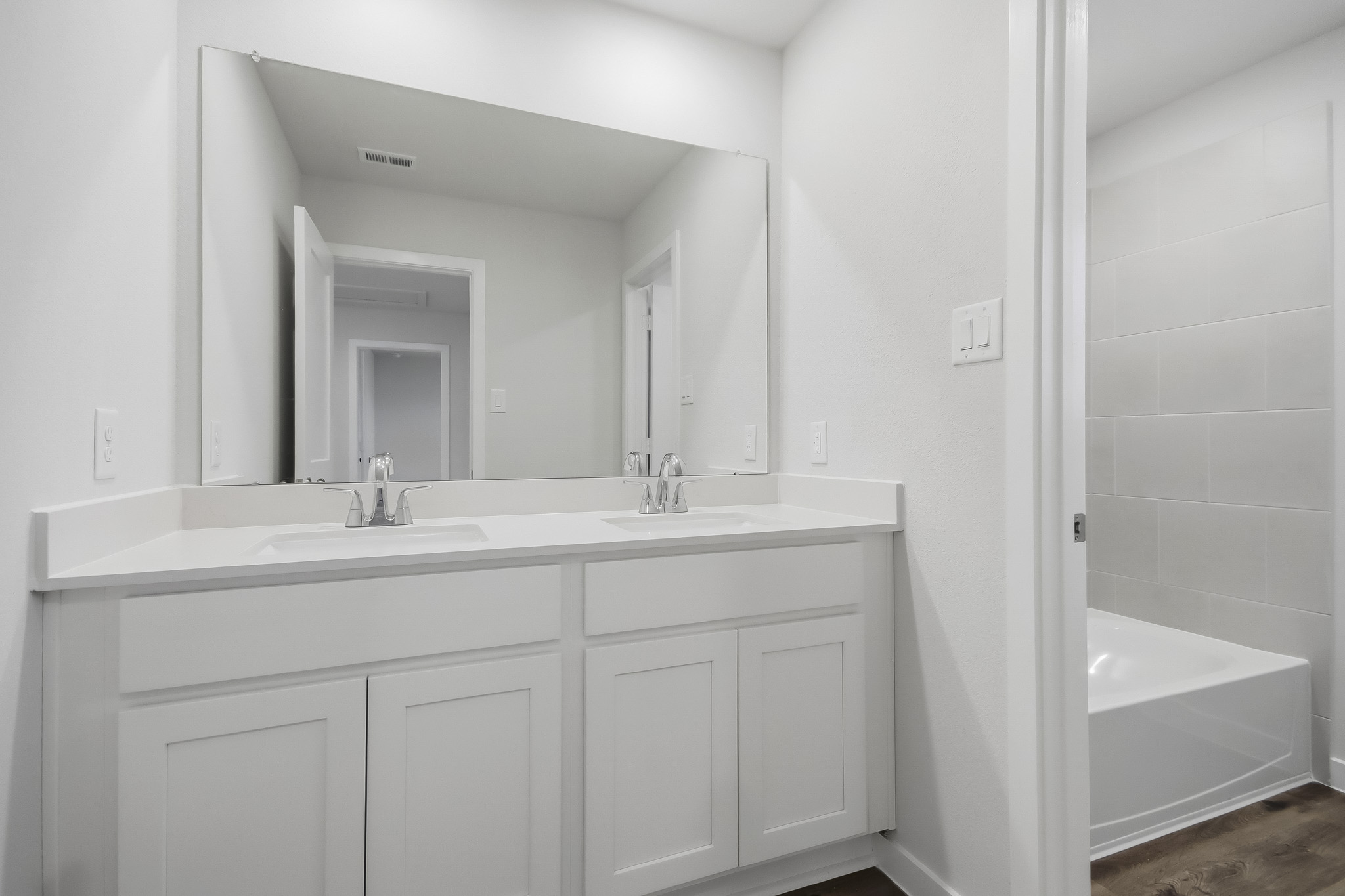 A bathroom with a sink and a tub.
