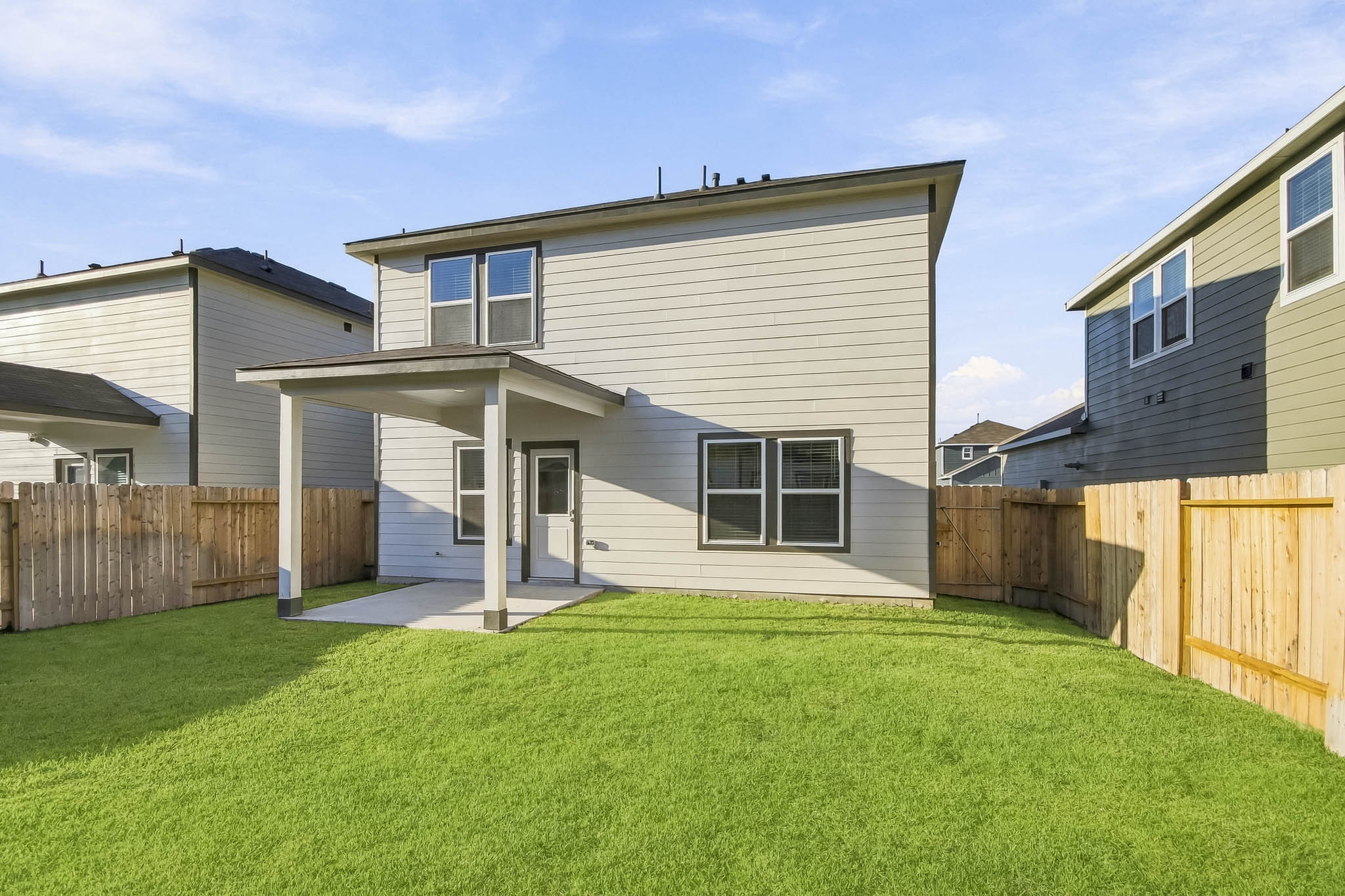 A house with a fence and grass.