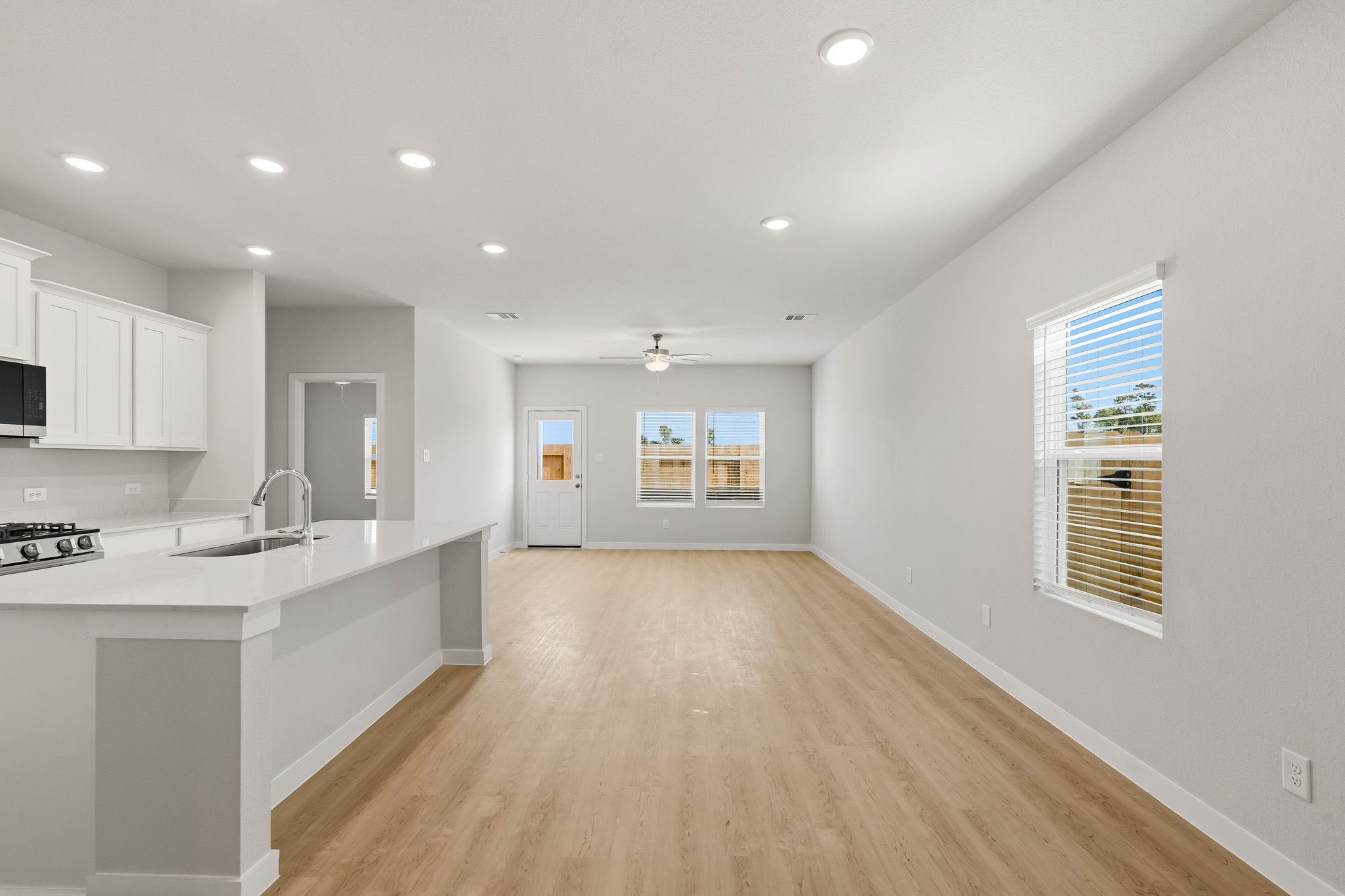 A kitchen with white cabinets.
