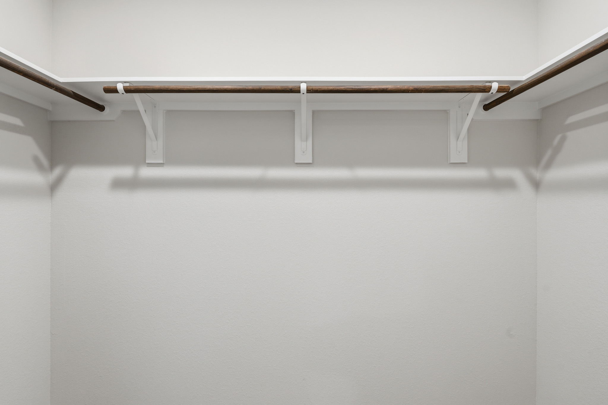A white ceiling with a metal bar.