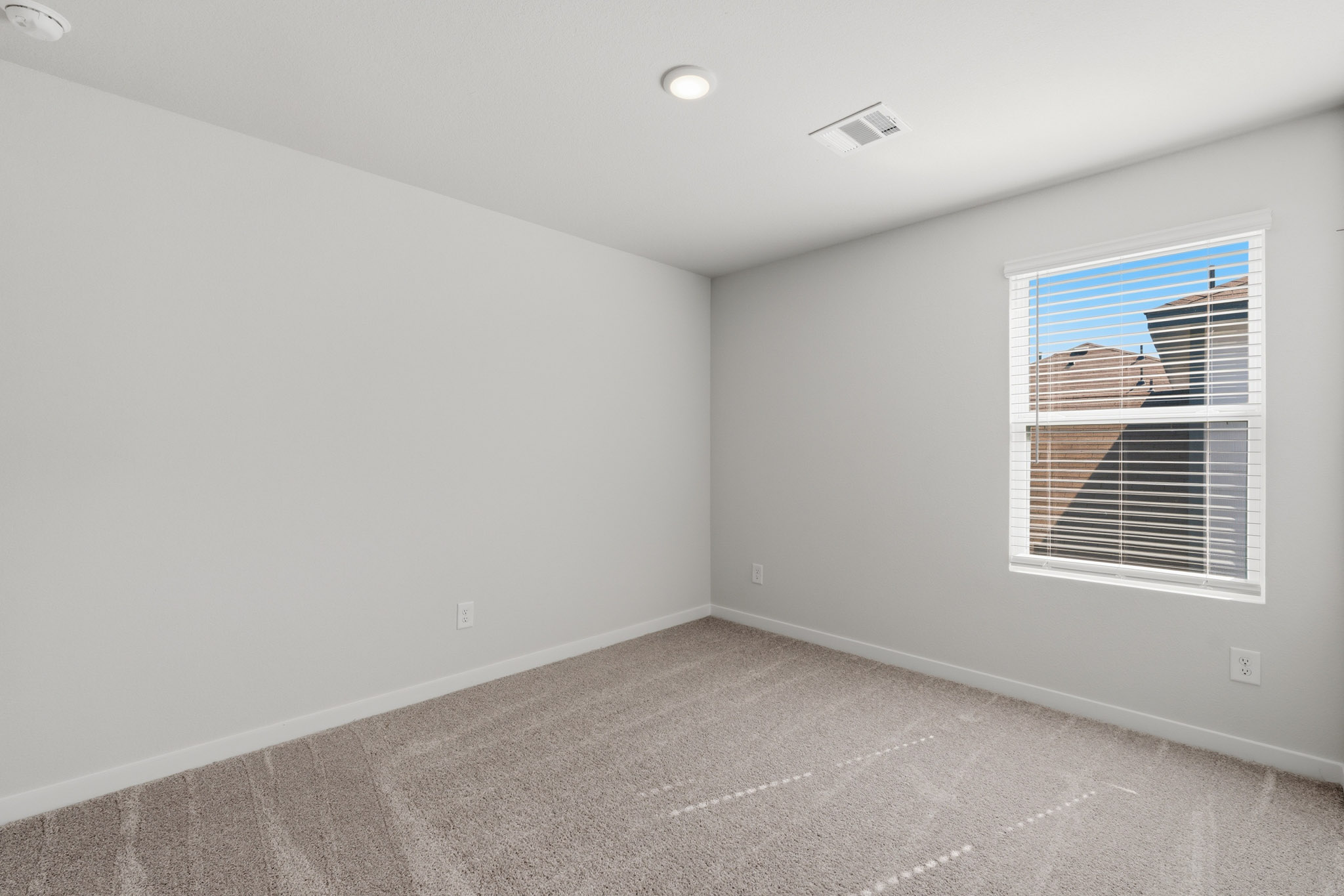 A room with a window and a vent.
