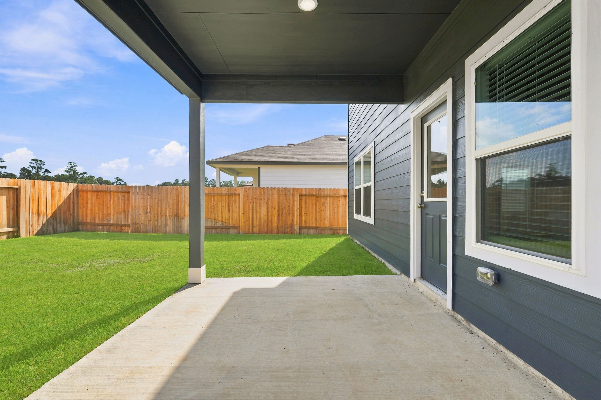 A house with a fence and grass.