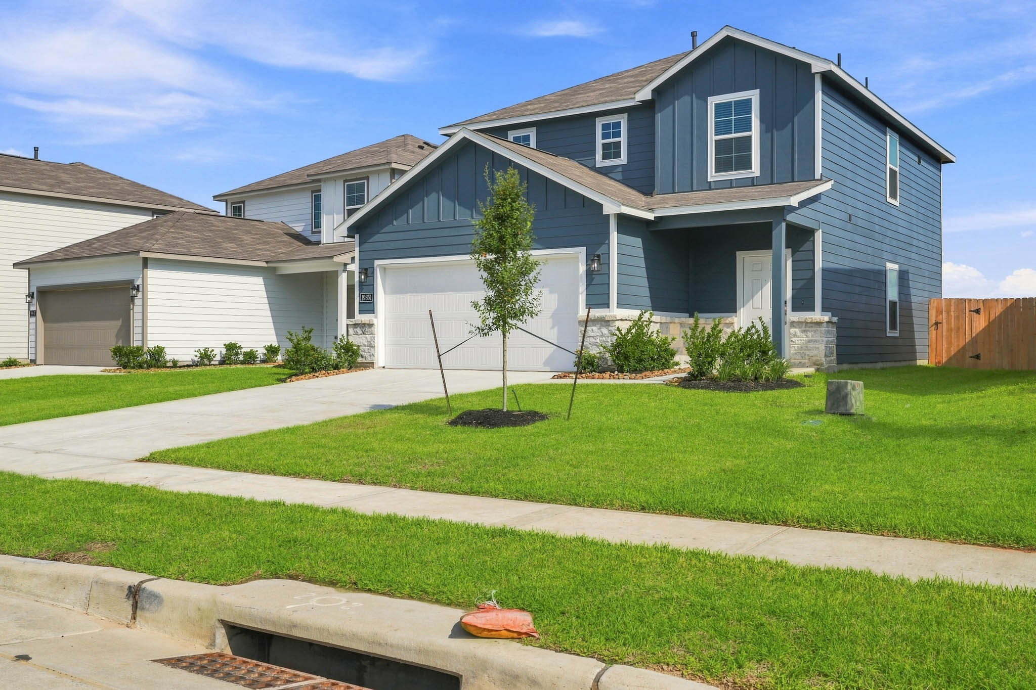 A house with a lawn and trees.