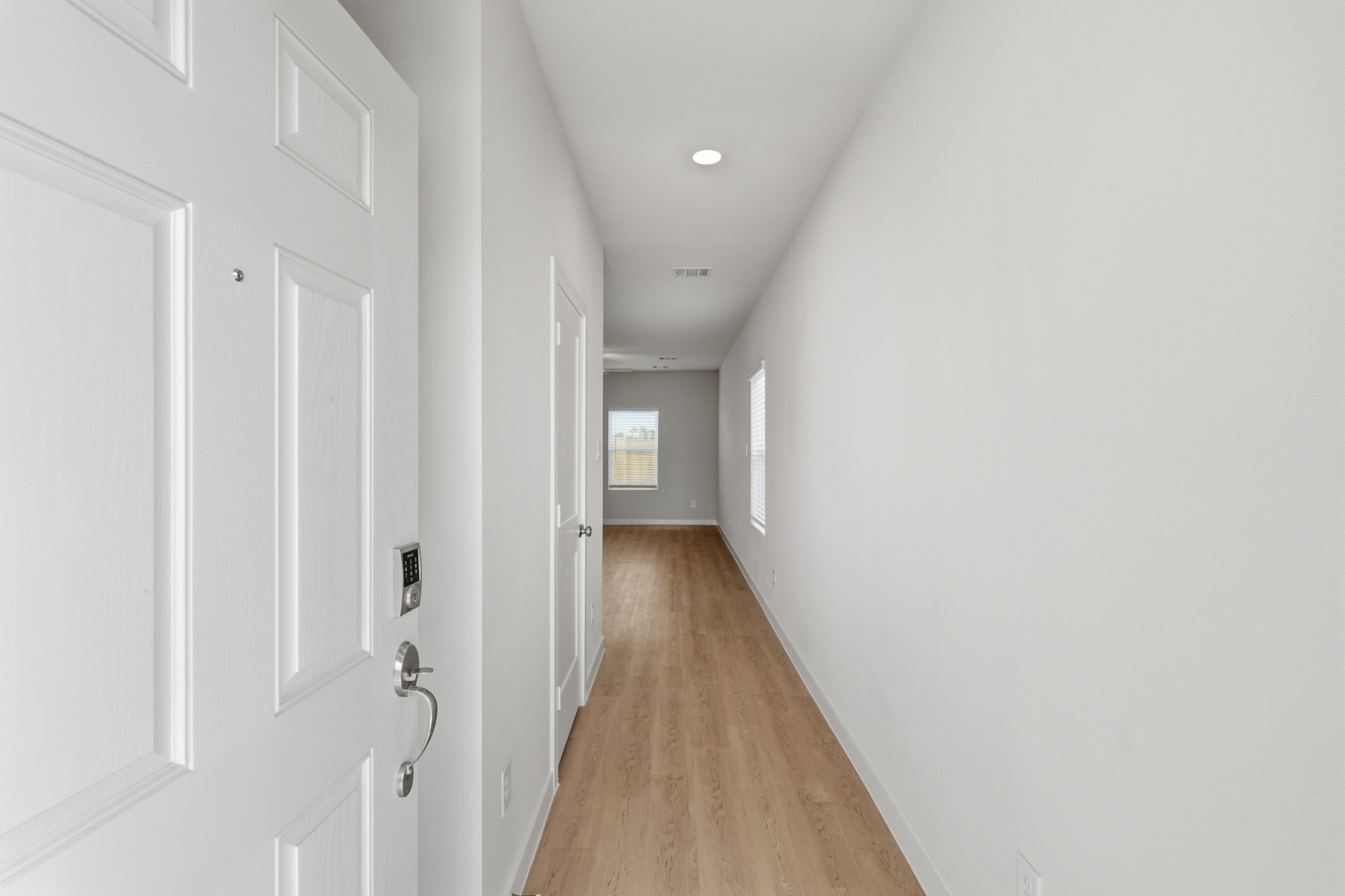 A hallway with white doors.