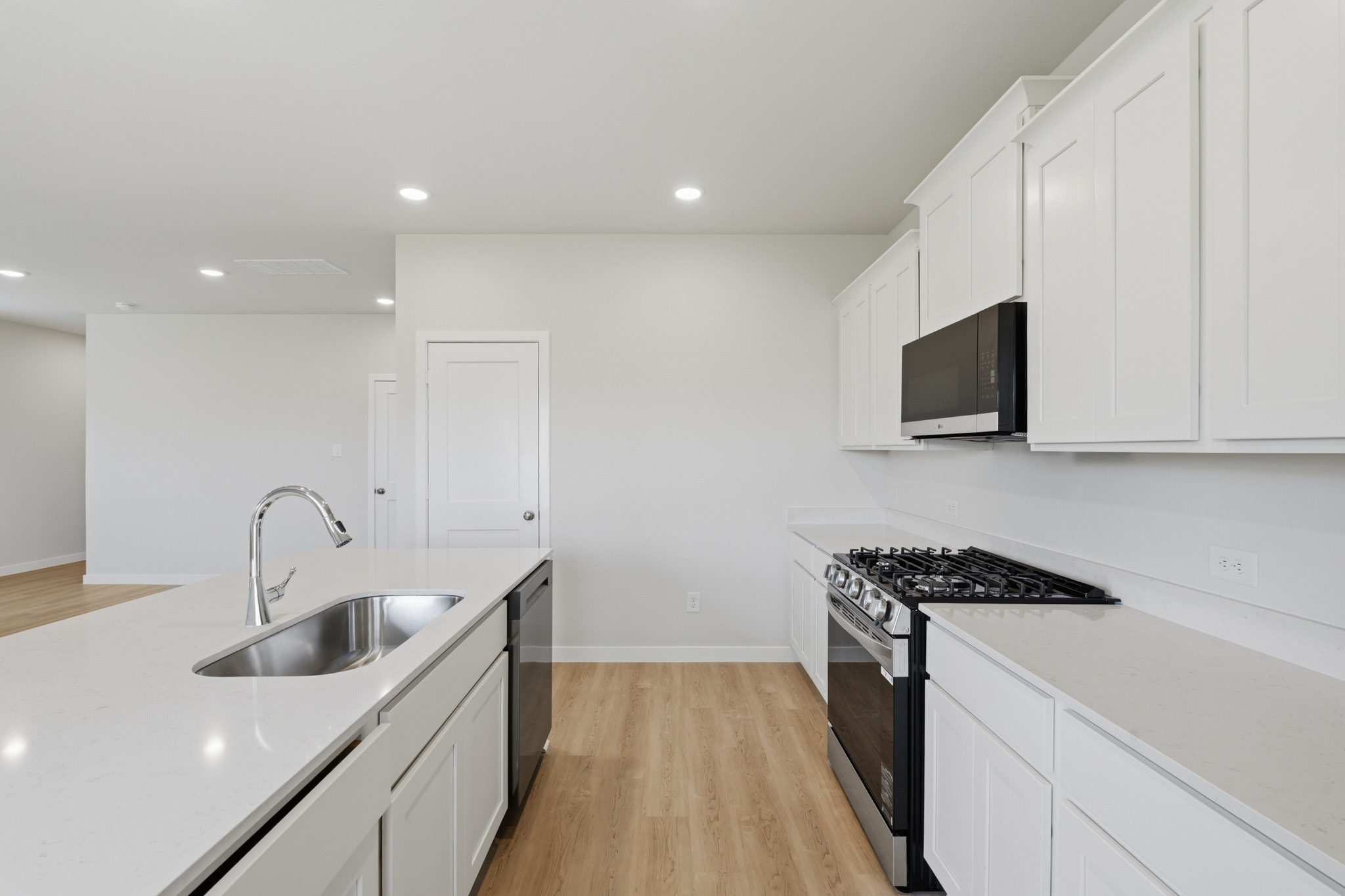 A kitchen with white cabinets.