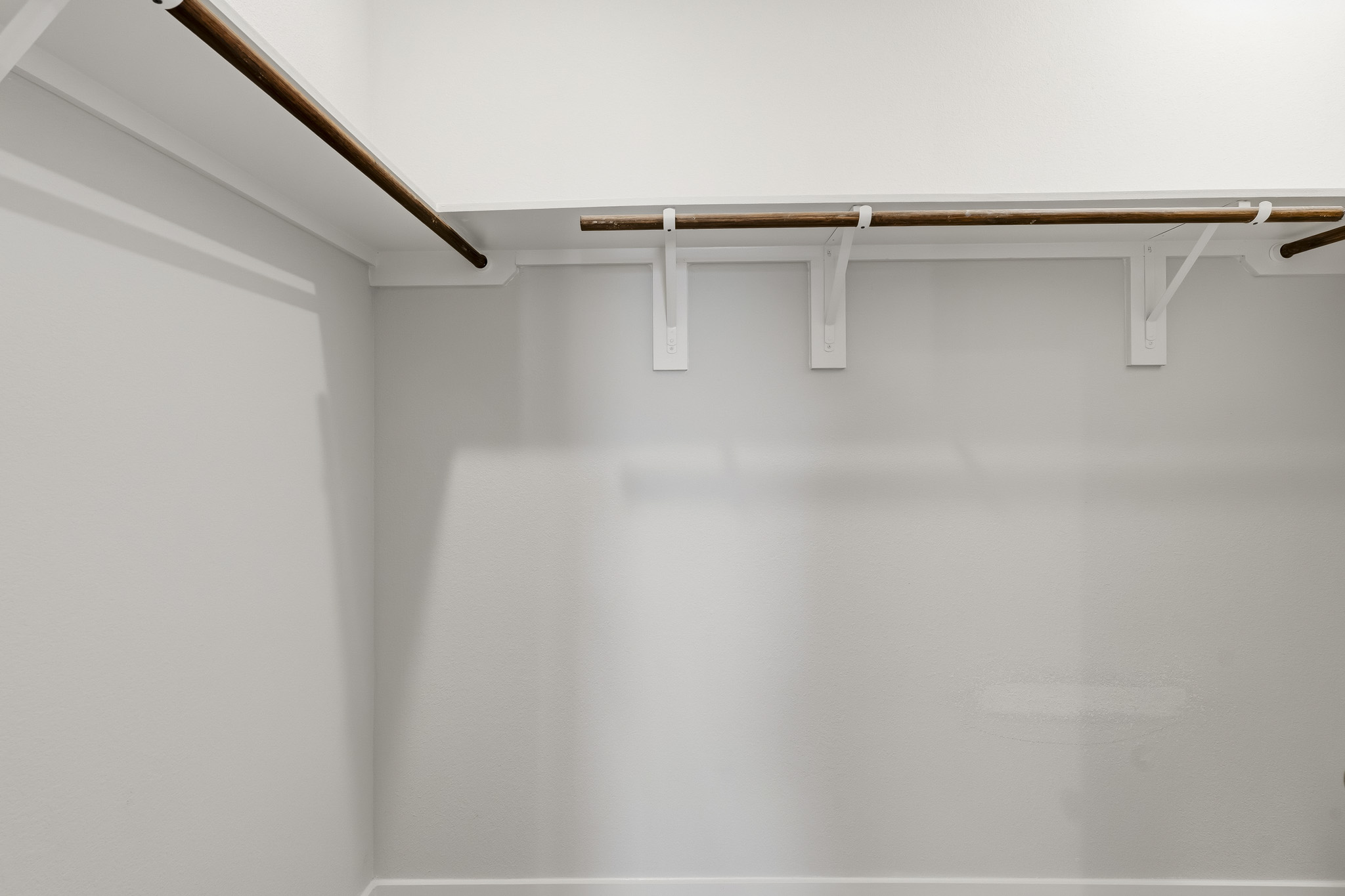 A metal bar on a white wall.