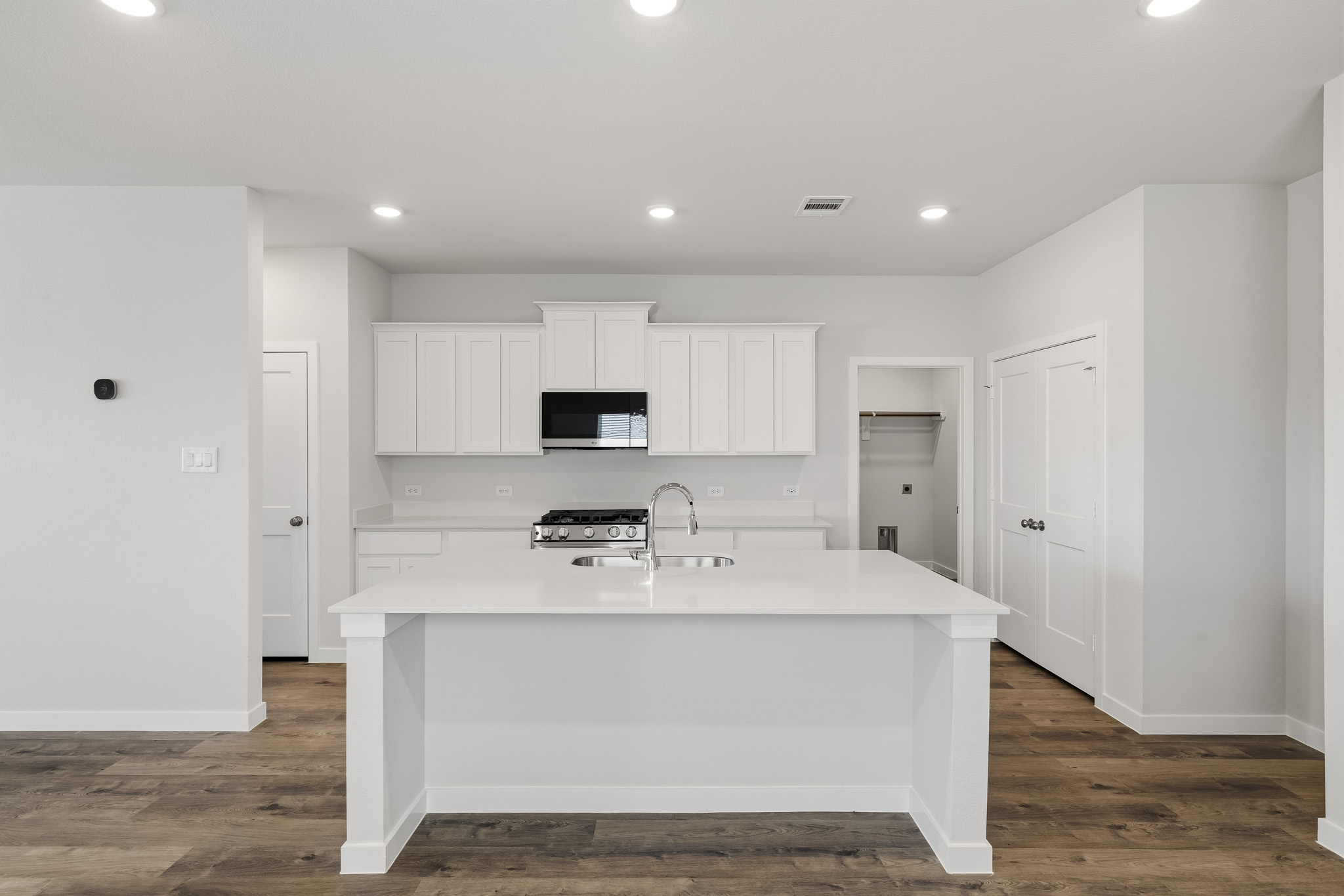 A kitchen with white cabinets.