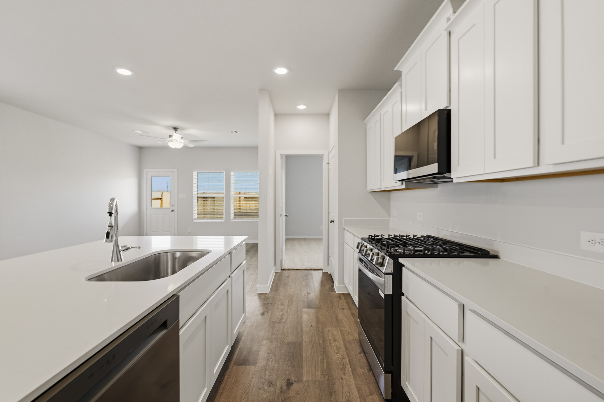 A kitchen with white cabinets.