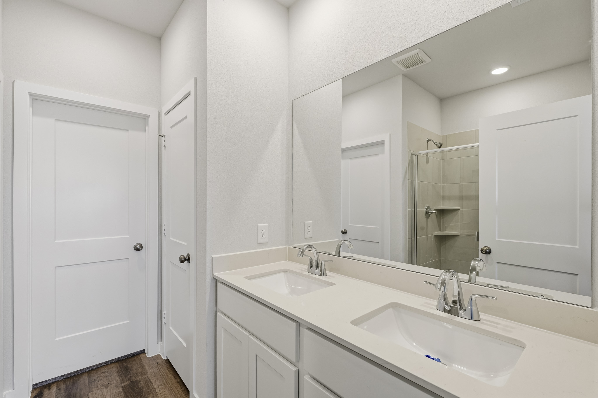A bathroom with a large mirror.