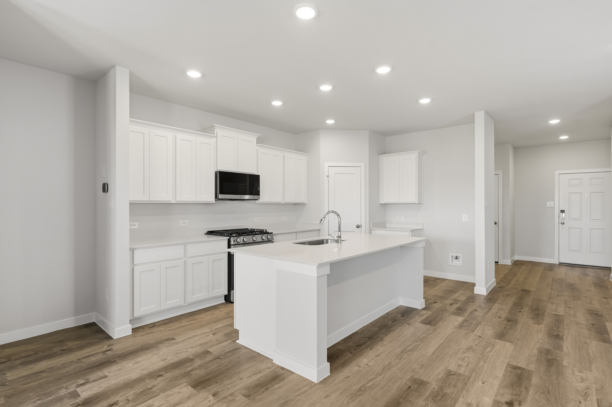 A kitchen with white cabinets.