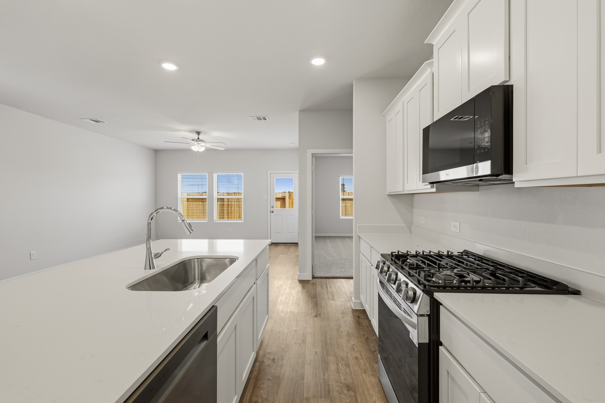 A kitchen with white cabinets.