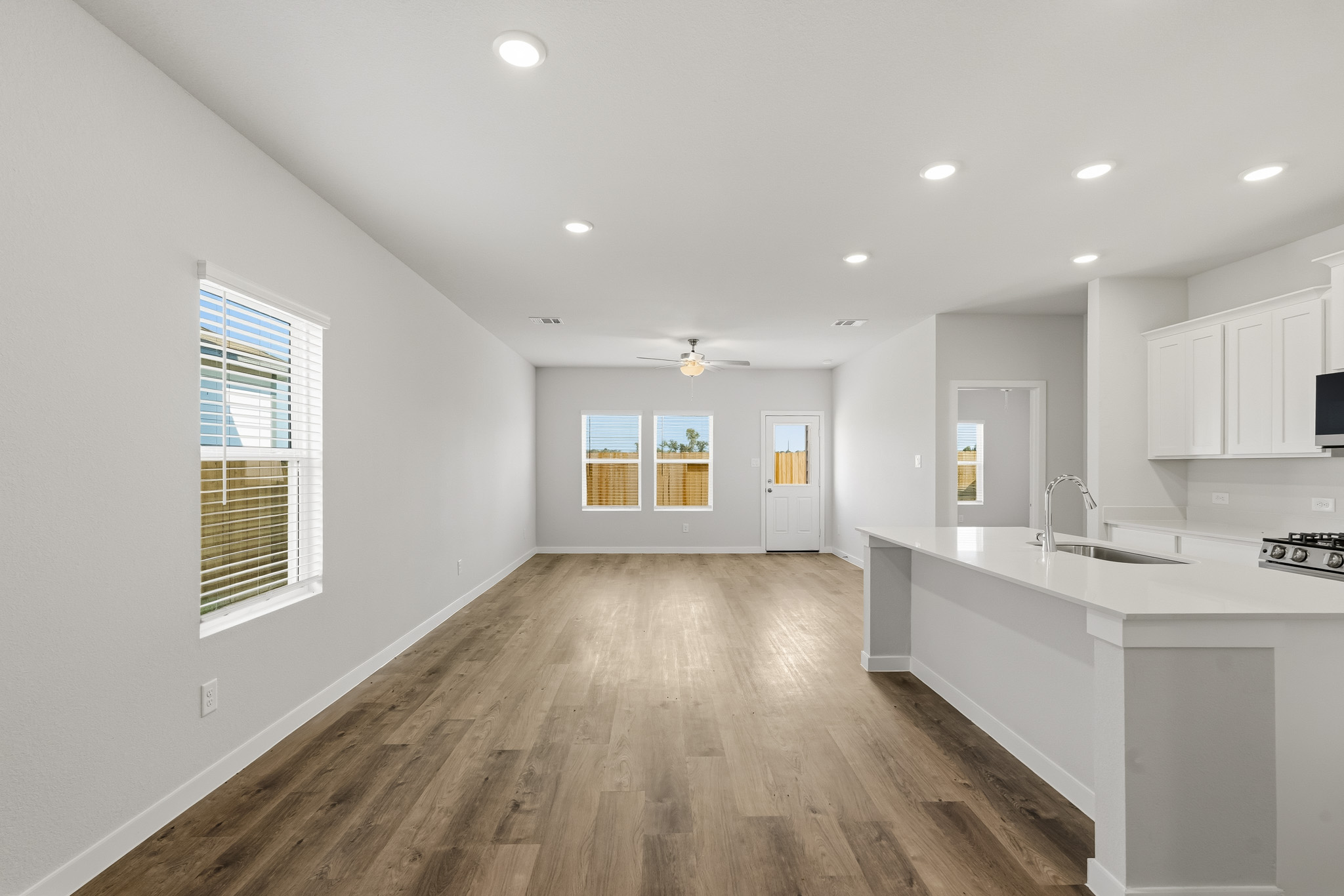 A kitchen with white cabinets.