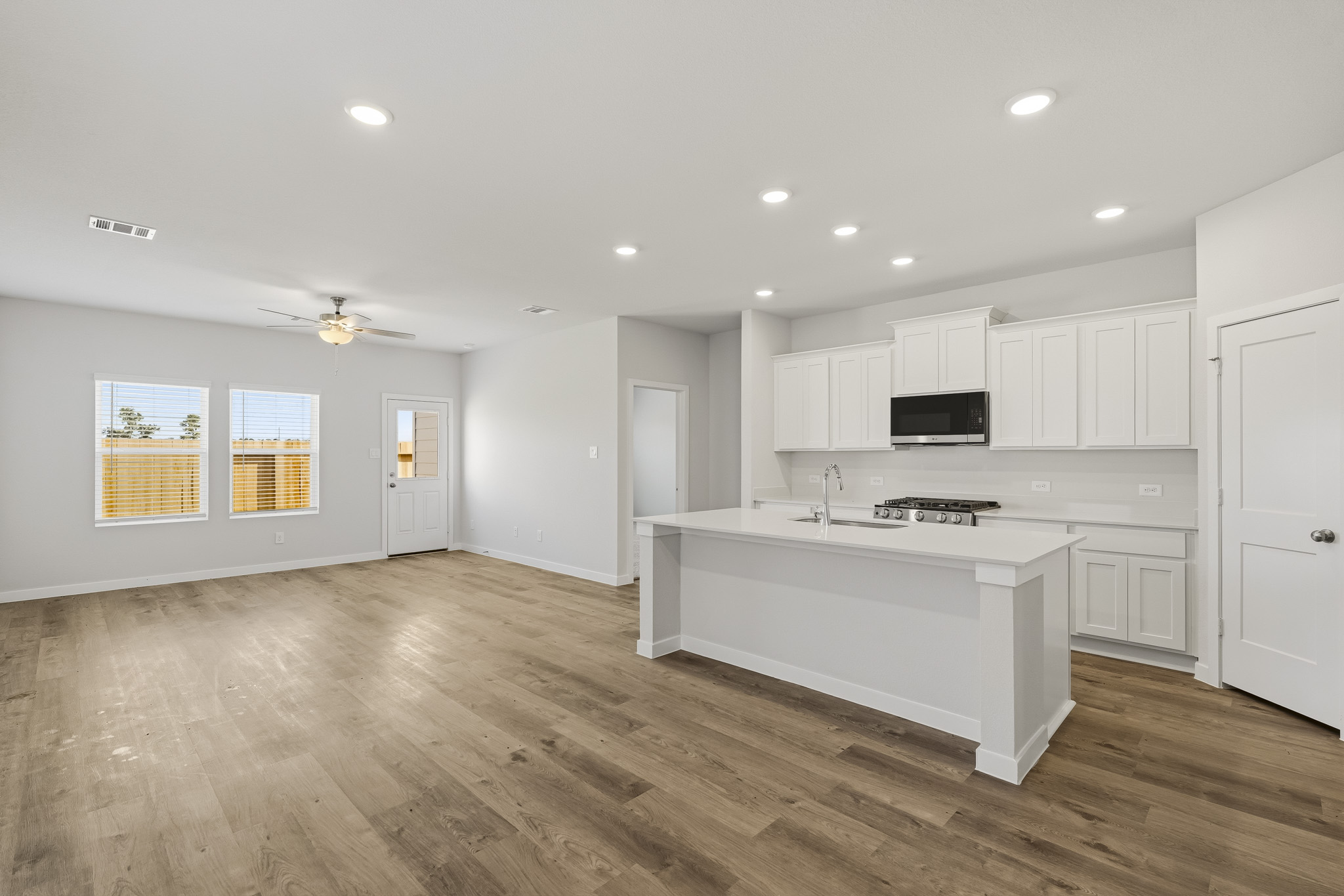 A kitchen with white cabinets.