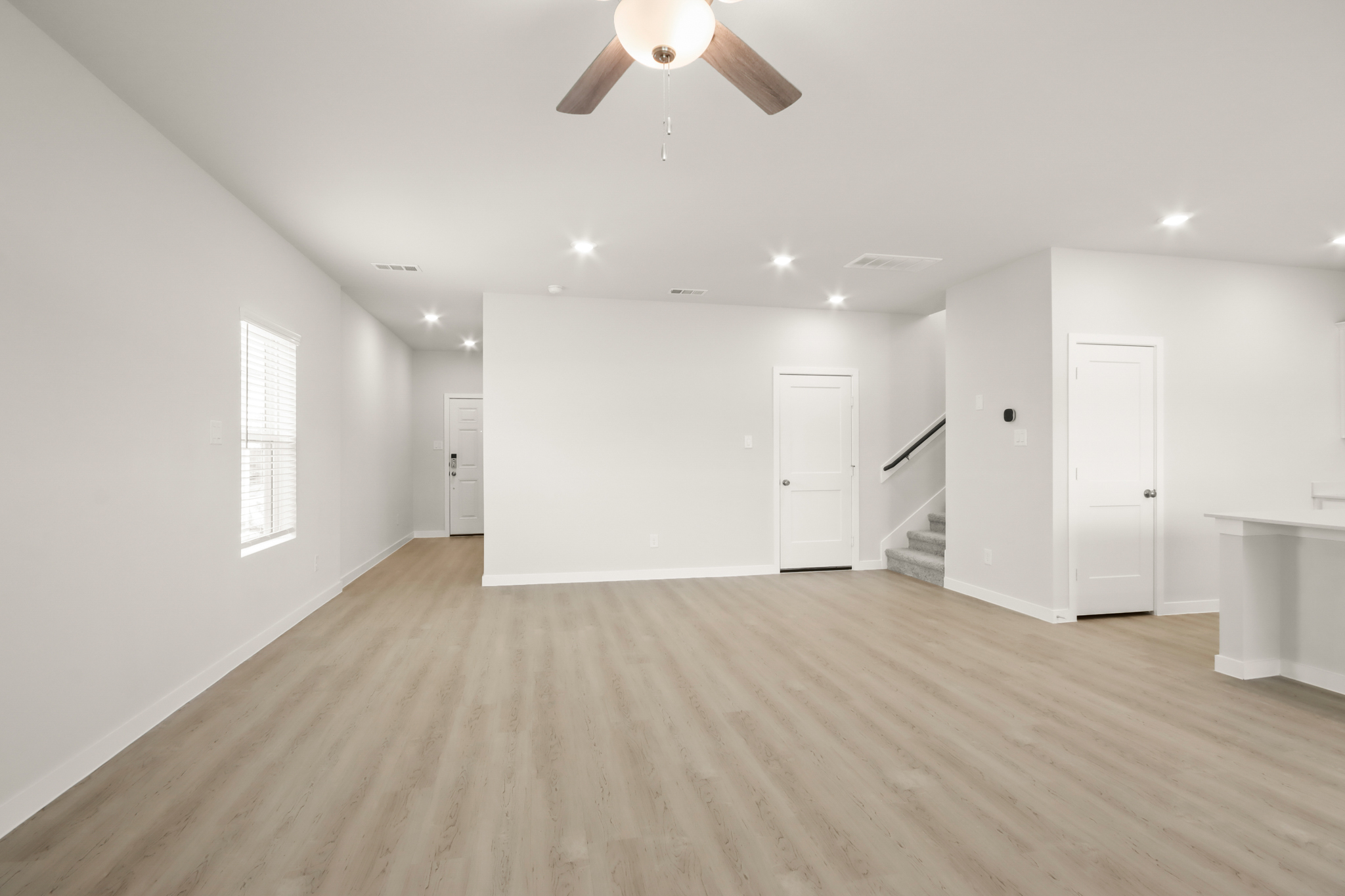 A room with white walls and a wood floor.