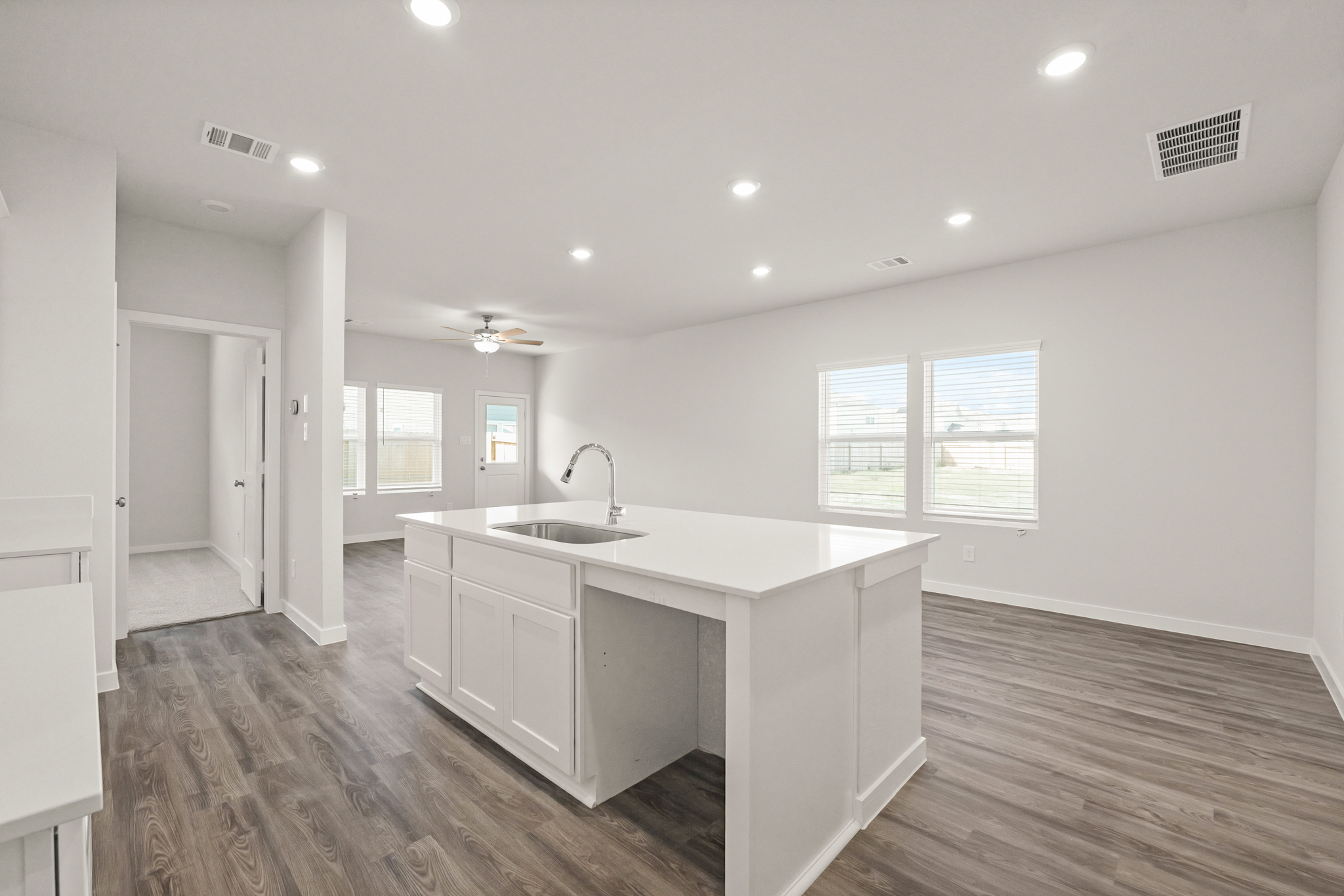 A kitchen with white cabinets.