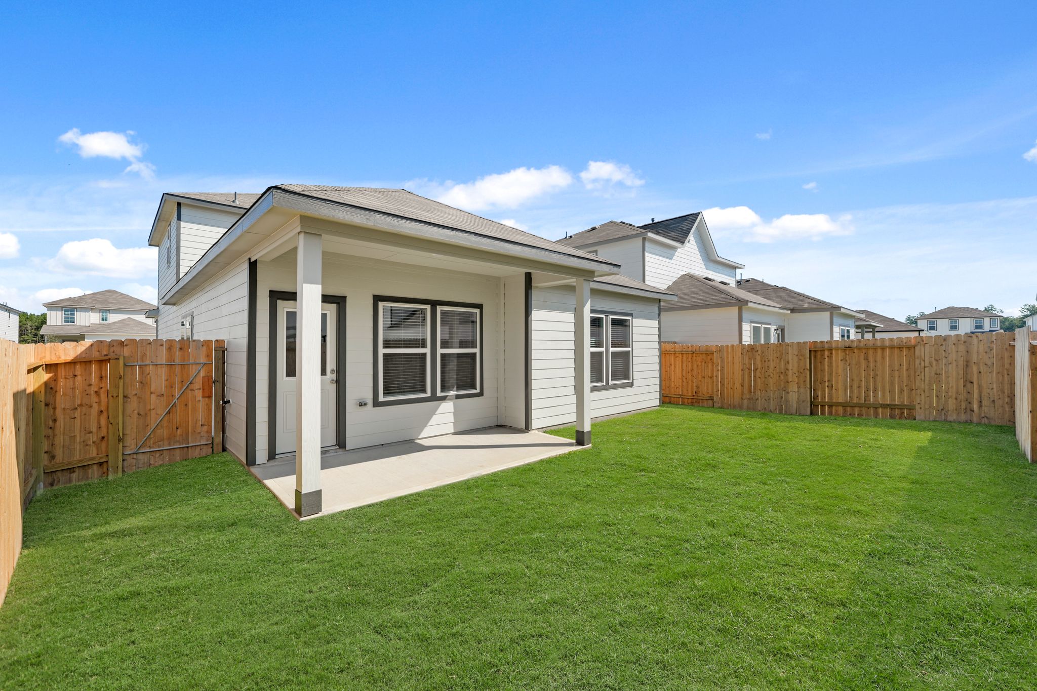 A house with a fence and grass.