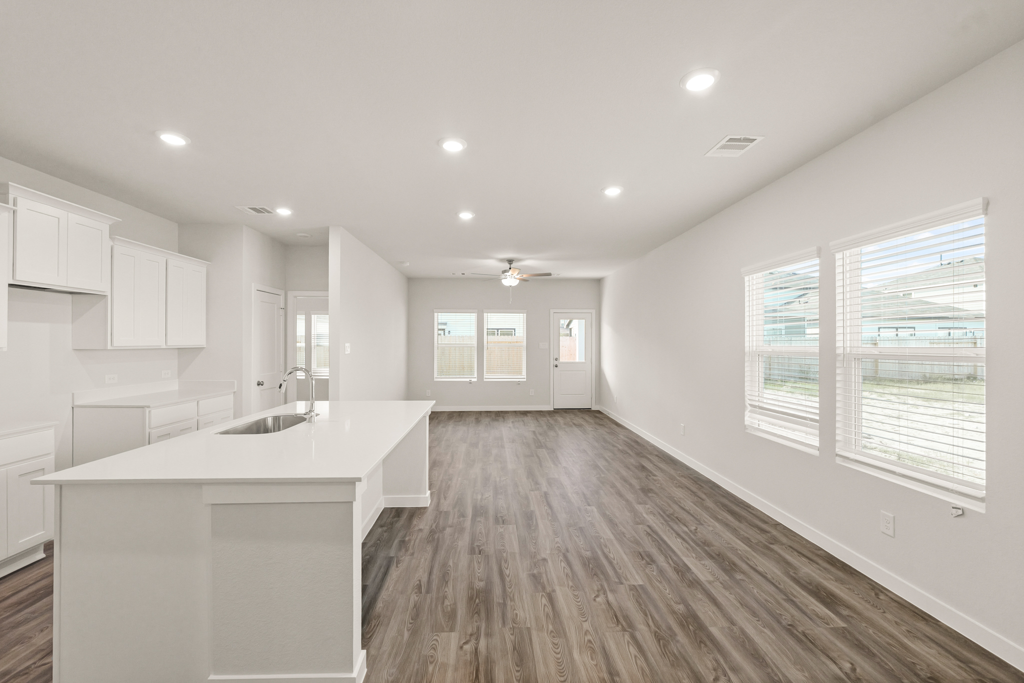 A kitchen with white cabinets.