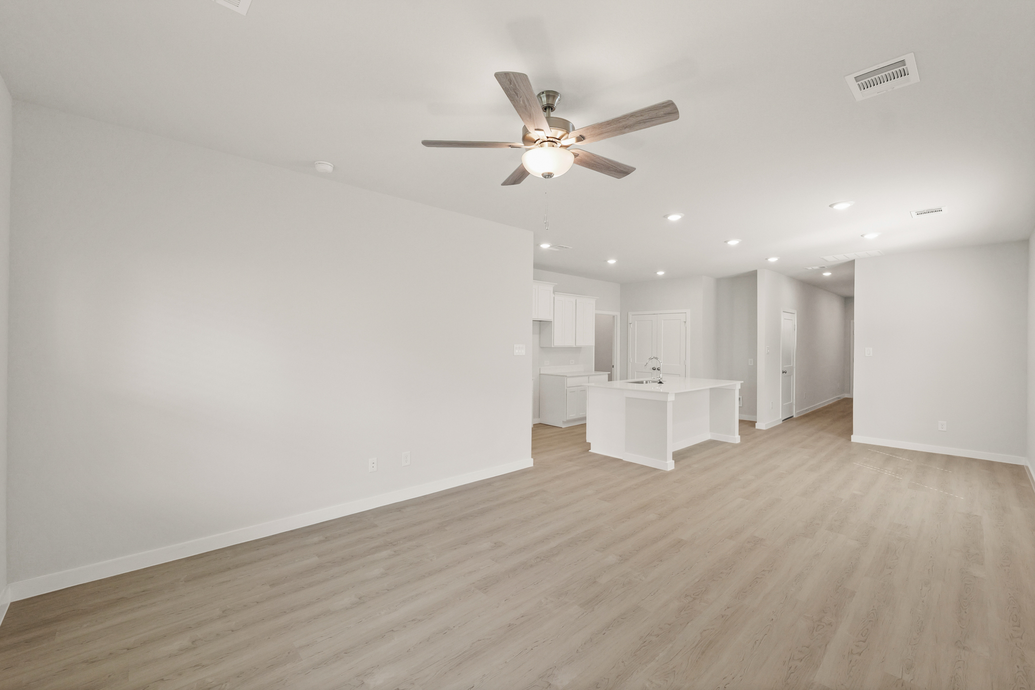 A room with a table and a ceiling fan.