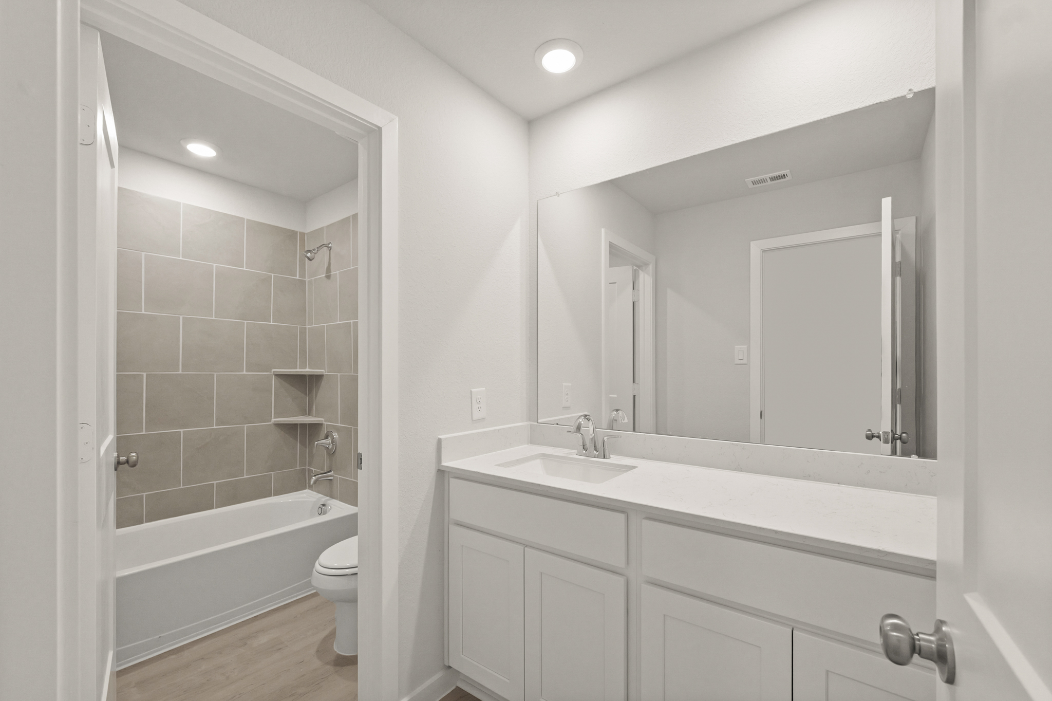 A bathroom with a tub sink and toilet.