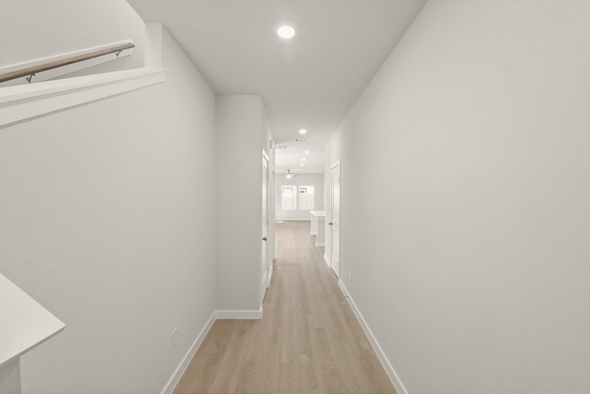 A long hallway with white walls.