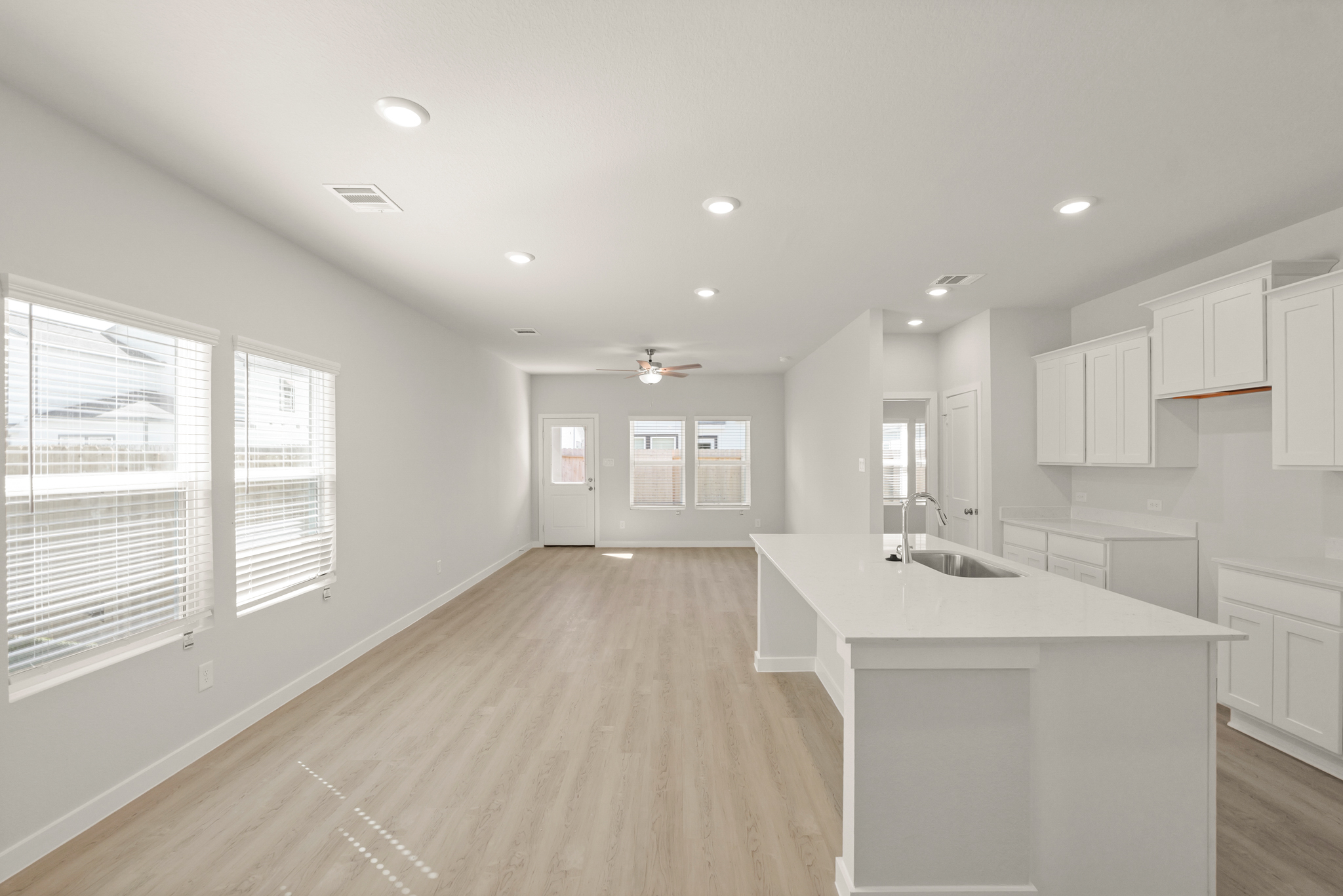 A kitchen with white cabinets.