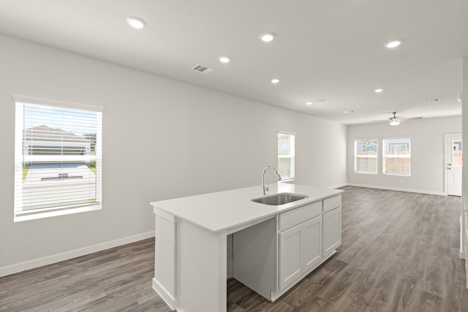 A kitchen with white cabinets.