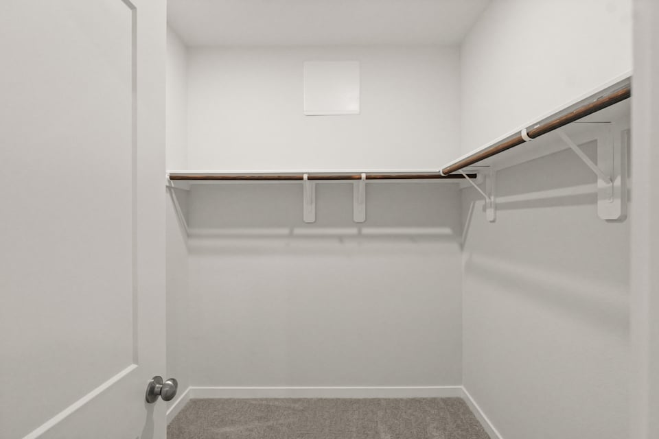 A white wall with a metal bar.