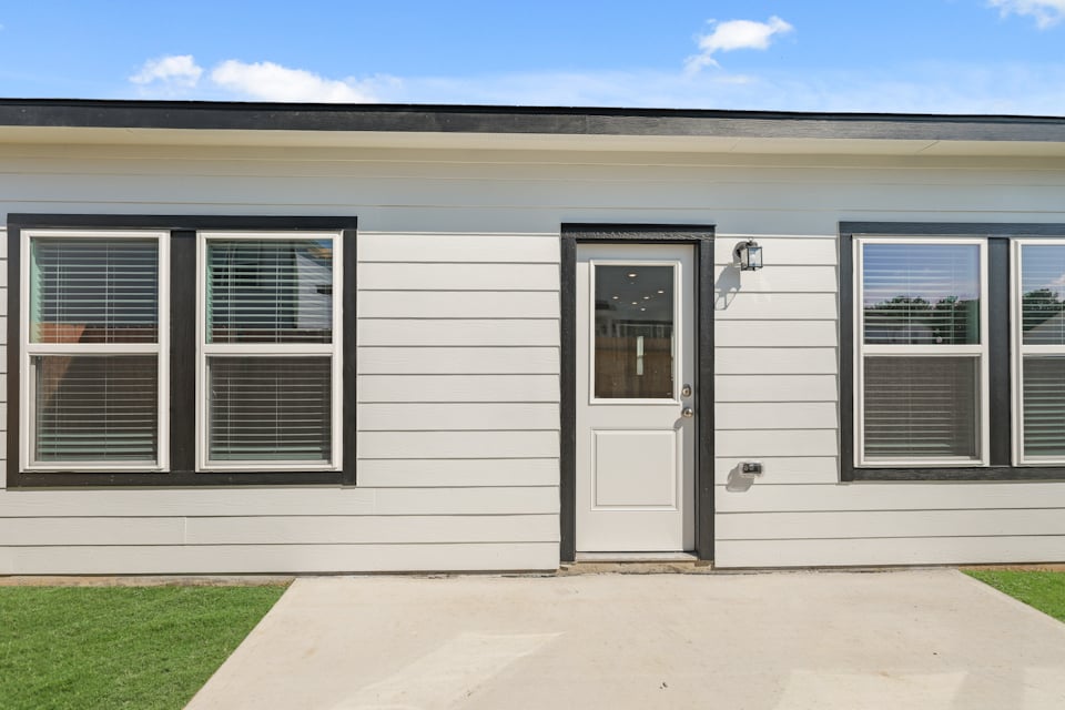 A white building with a door.