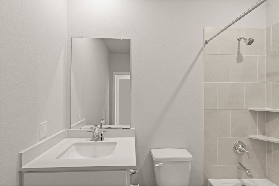 A bathroom with a sink and a mirror.