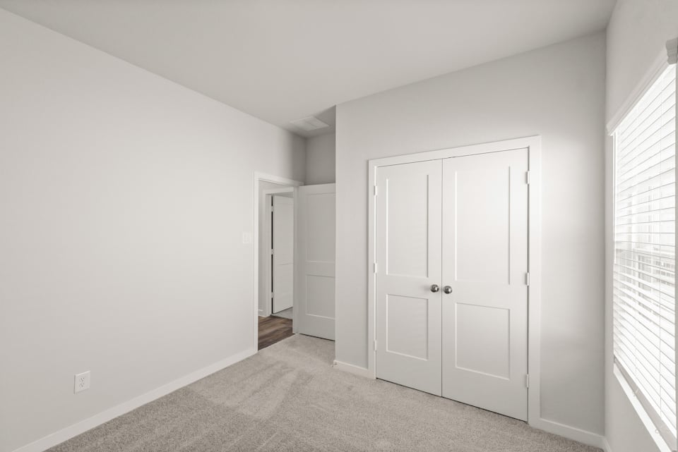 A hallway with white doors.