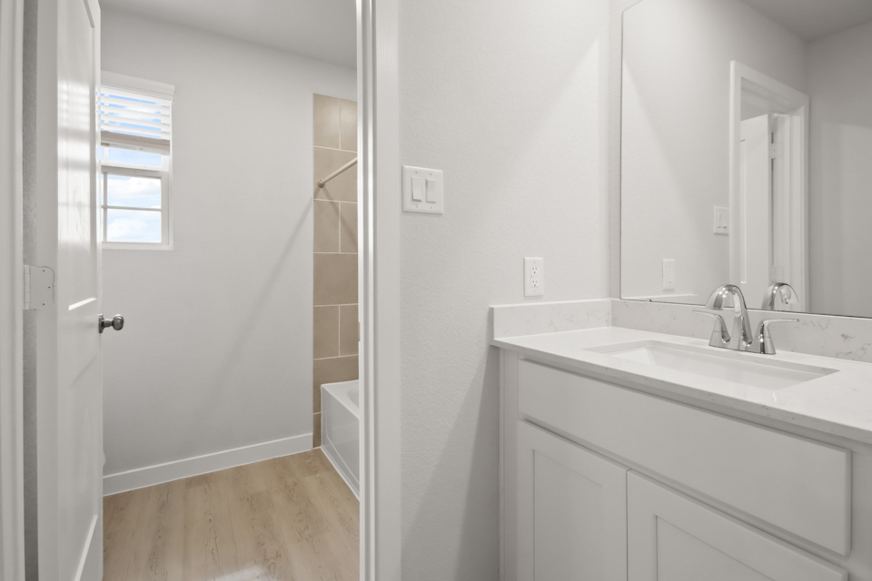 A bathroom with a sink and a mirror.