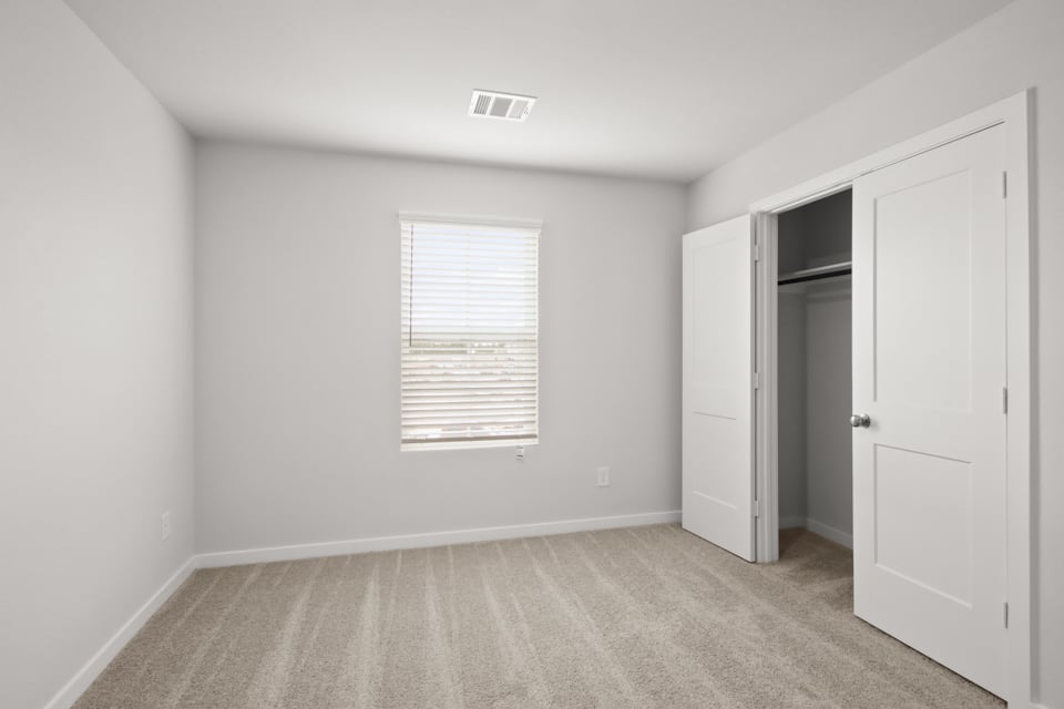 A room with white walls and a door.