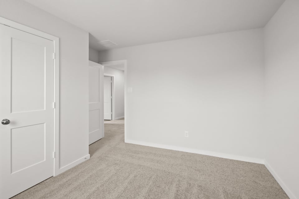 A hallway with white doors.