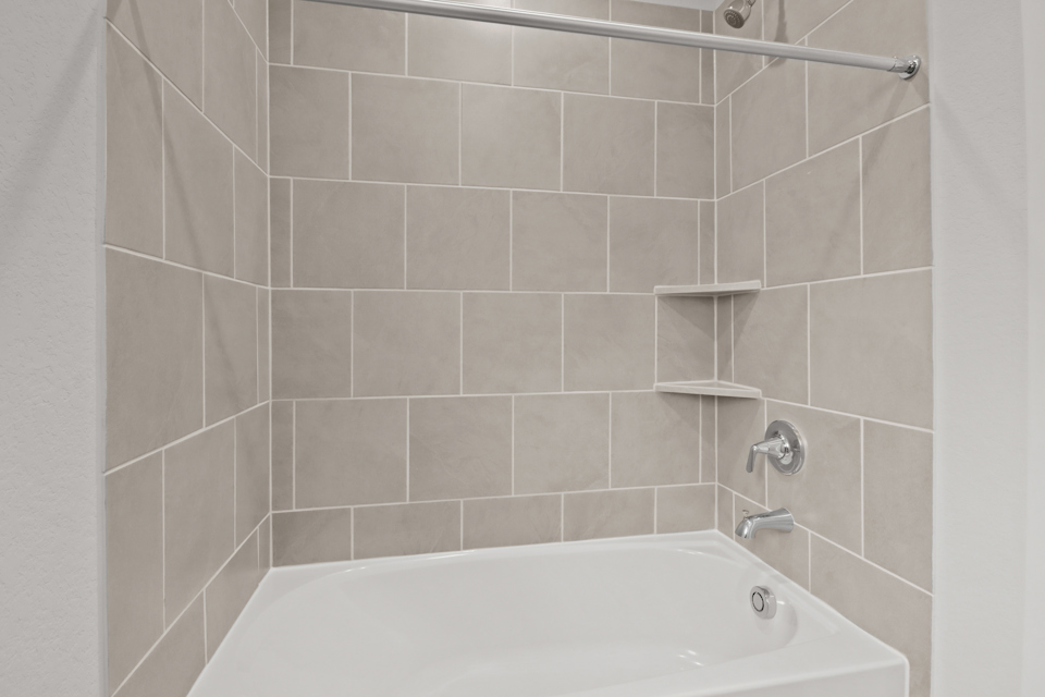 A bathtub in a bathroom.