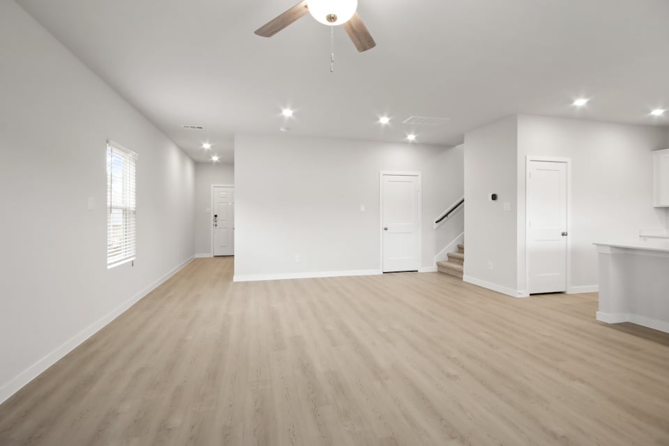 A room with white walls and a wood floor.
