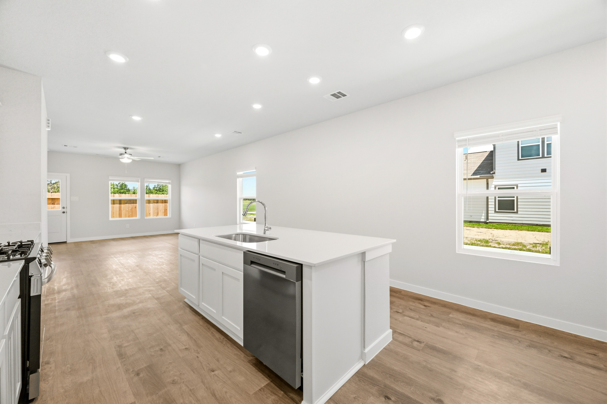A kitchen with white cabinets.