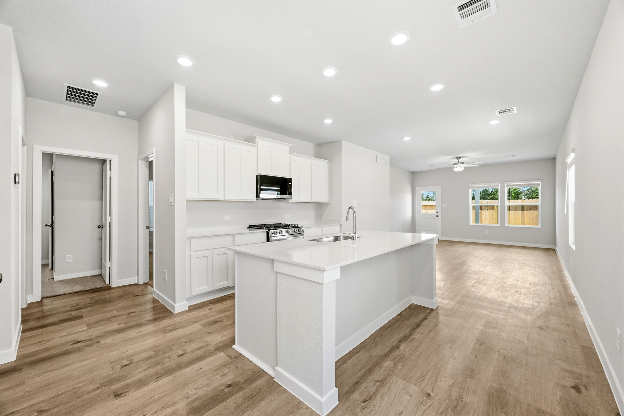 A kitchen with white cabinets.