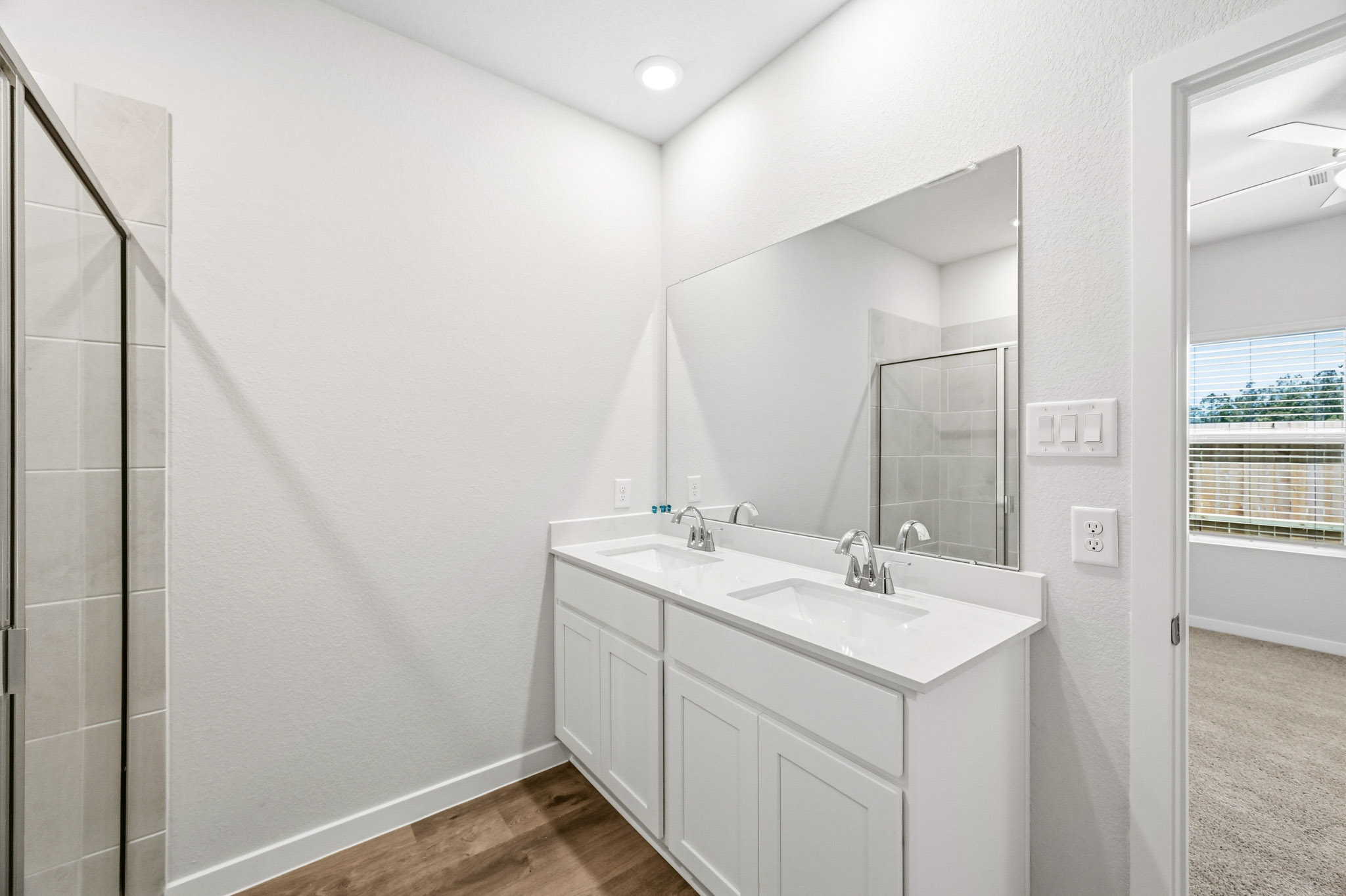 A bathroom with a large mirror.
