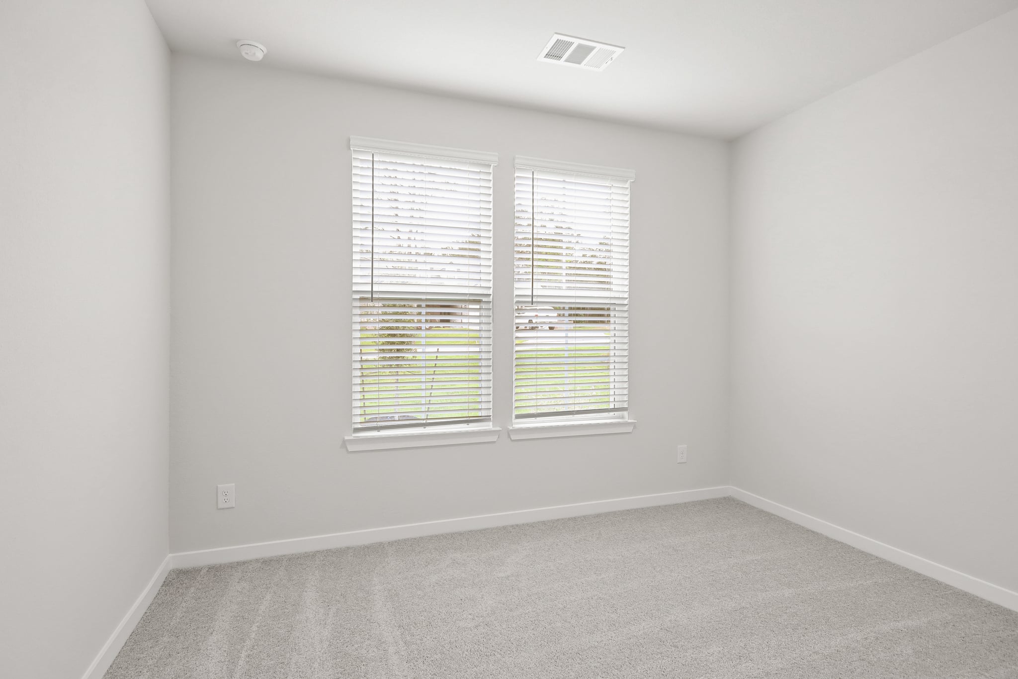 A room with a window and a carpet.