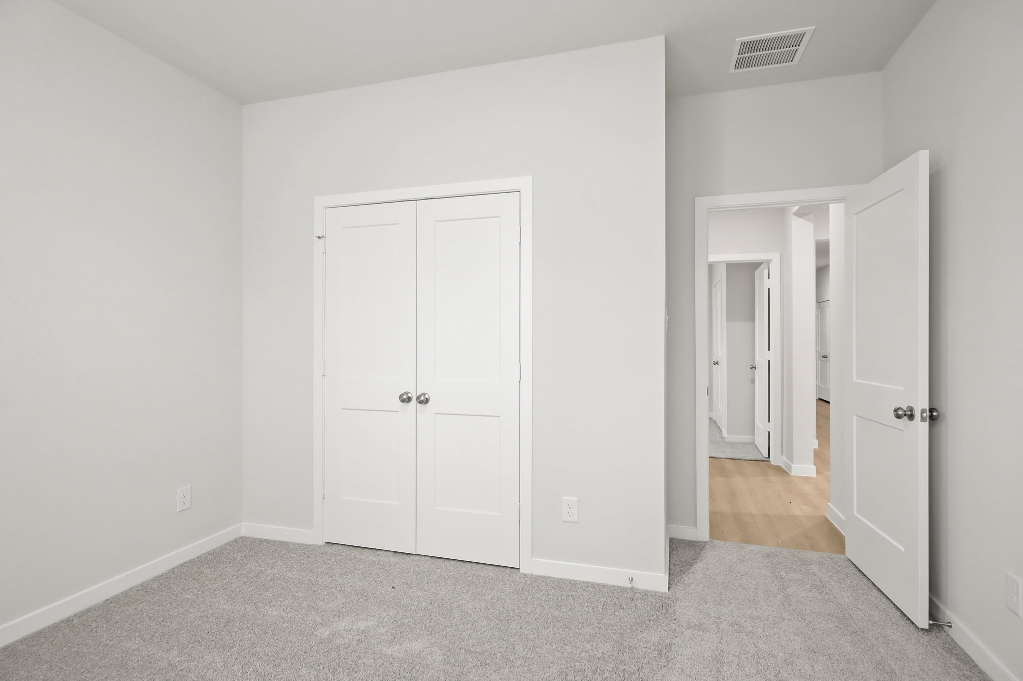 A hallway with white doors.