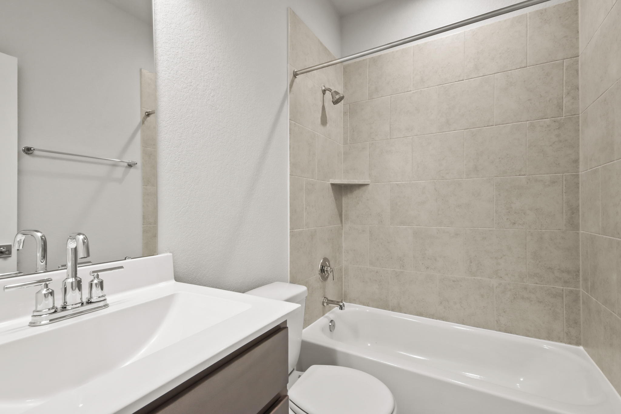A bathroom with a tub sink and toilet.