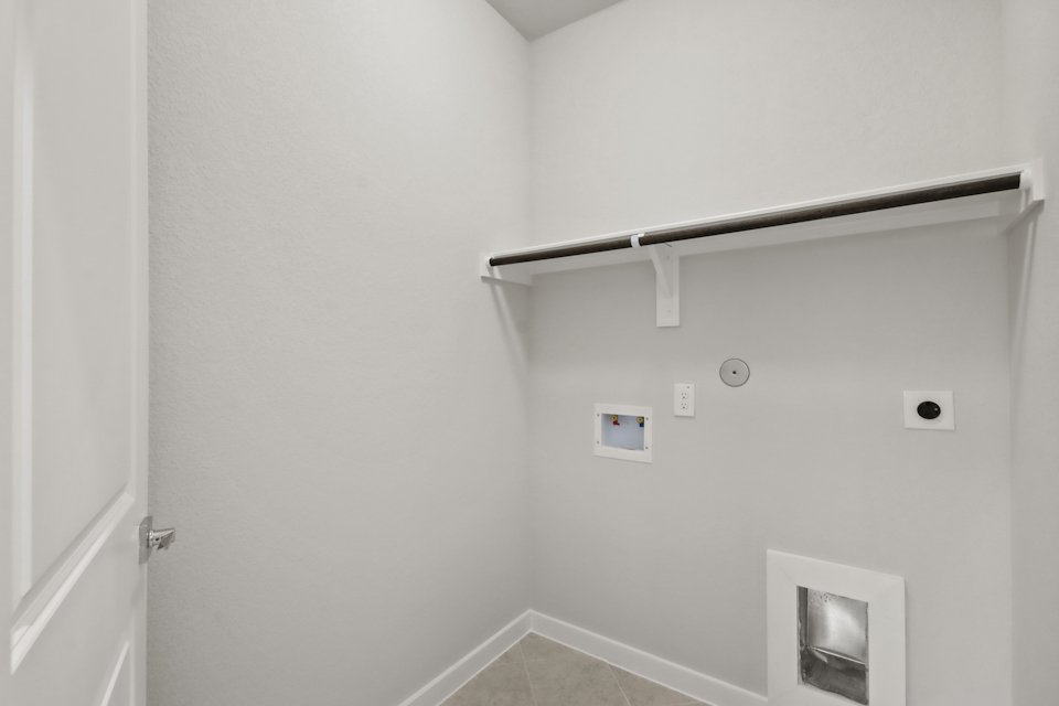 A shower with a metal bar.