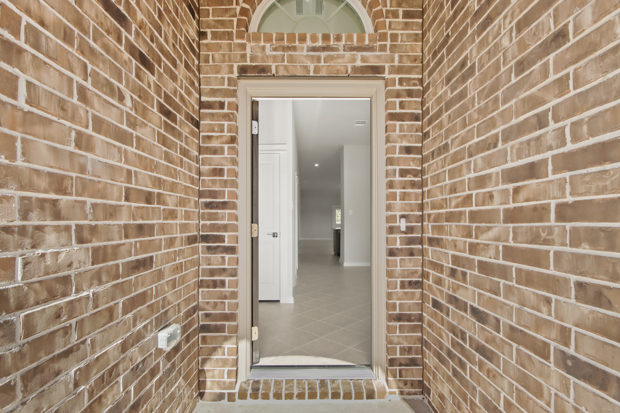 A brick wall with a door.