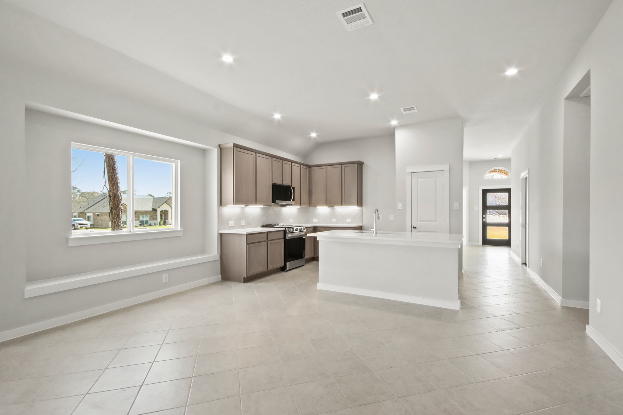 A large kitchen with a large window.